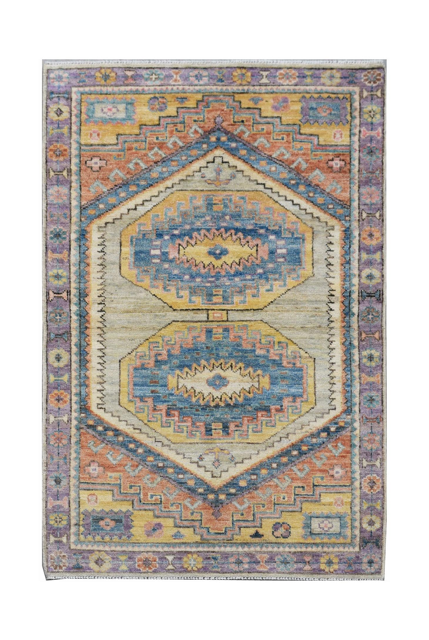 A handwoven transitional Oushak rug featuring geometric patterns in blue, orange, and yellow tones.