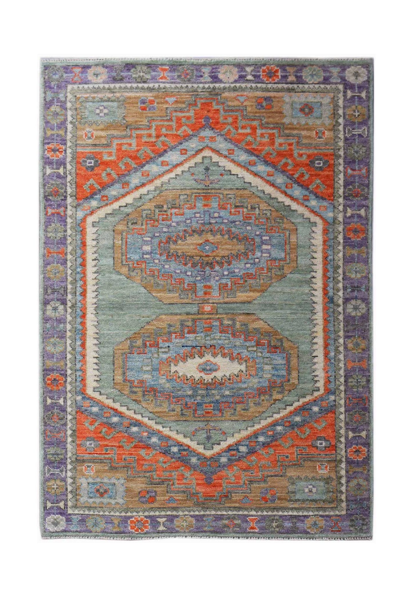 A handwoven transitional Oushak rug featuring geometric patterns in blue, orange, and tan tones.