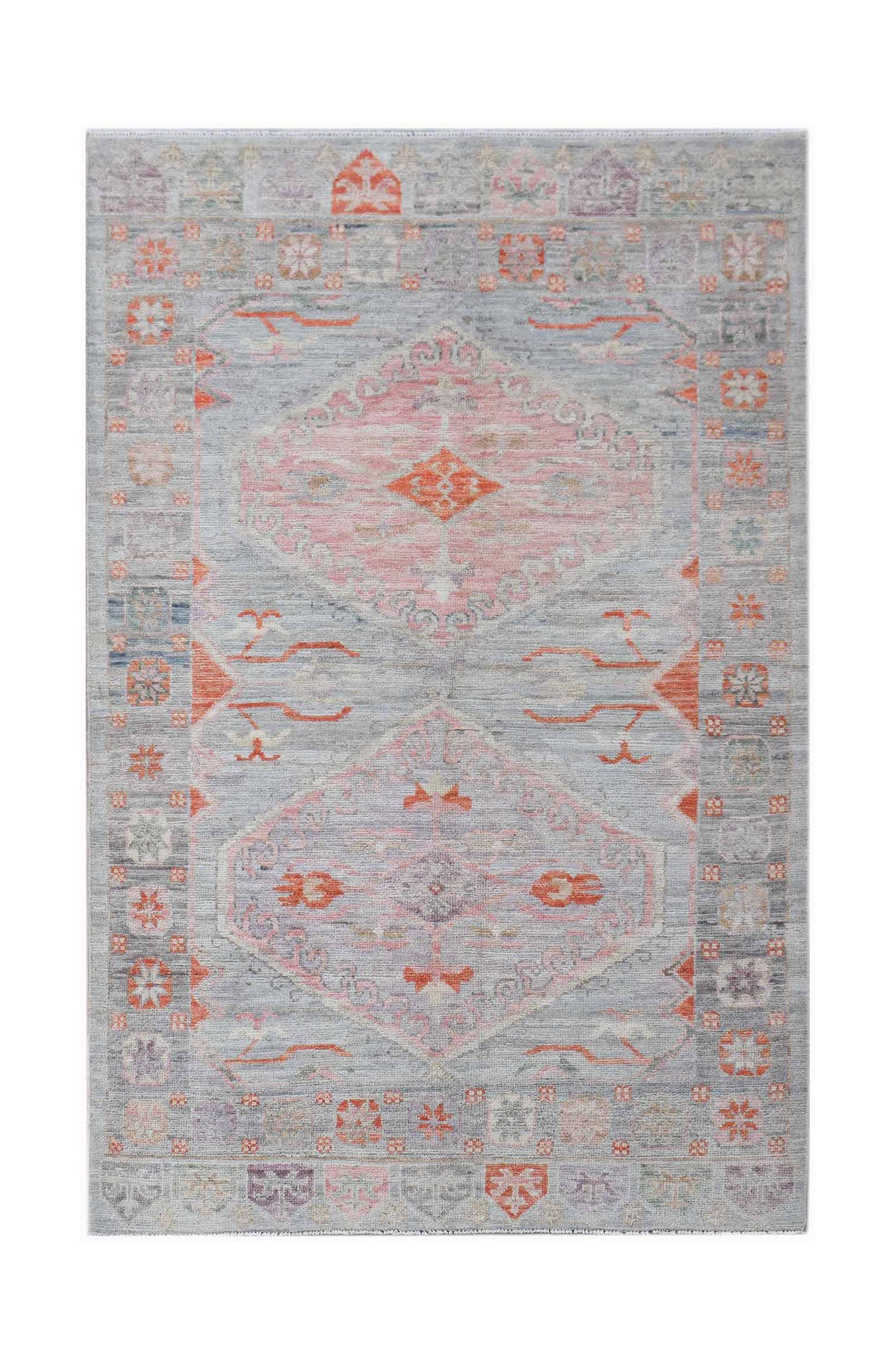 A handwoven transitional Oushak rug featuring a light grey field with pink and orange motifs.