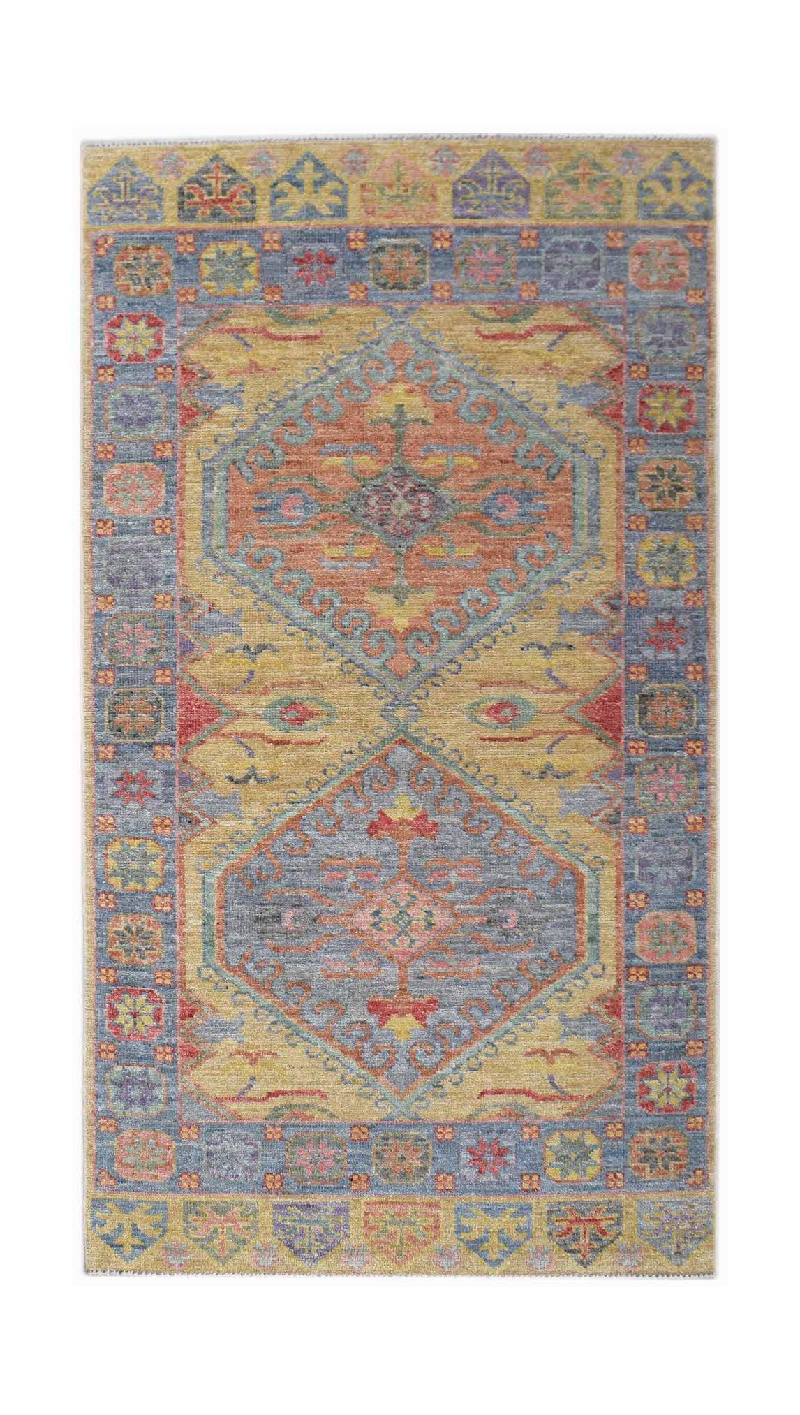 A handwoven transitional Oushak rug featuring a geometric floral pattern in blue, gold, and red.