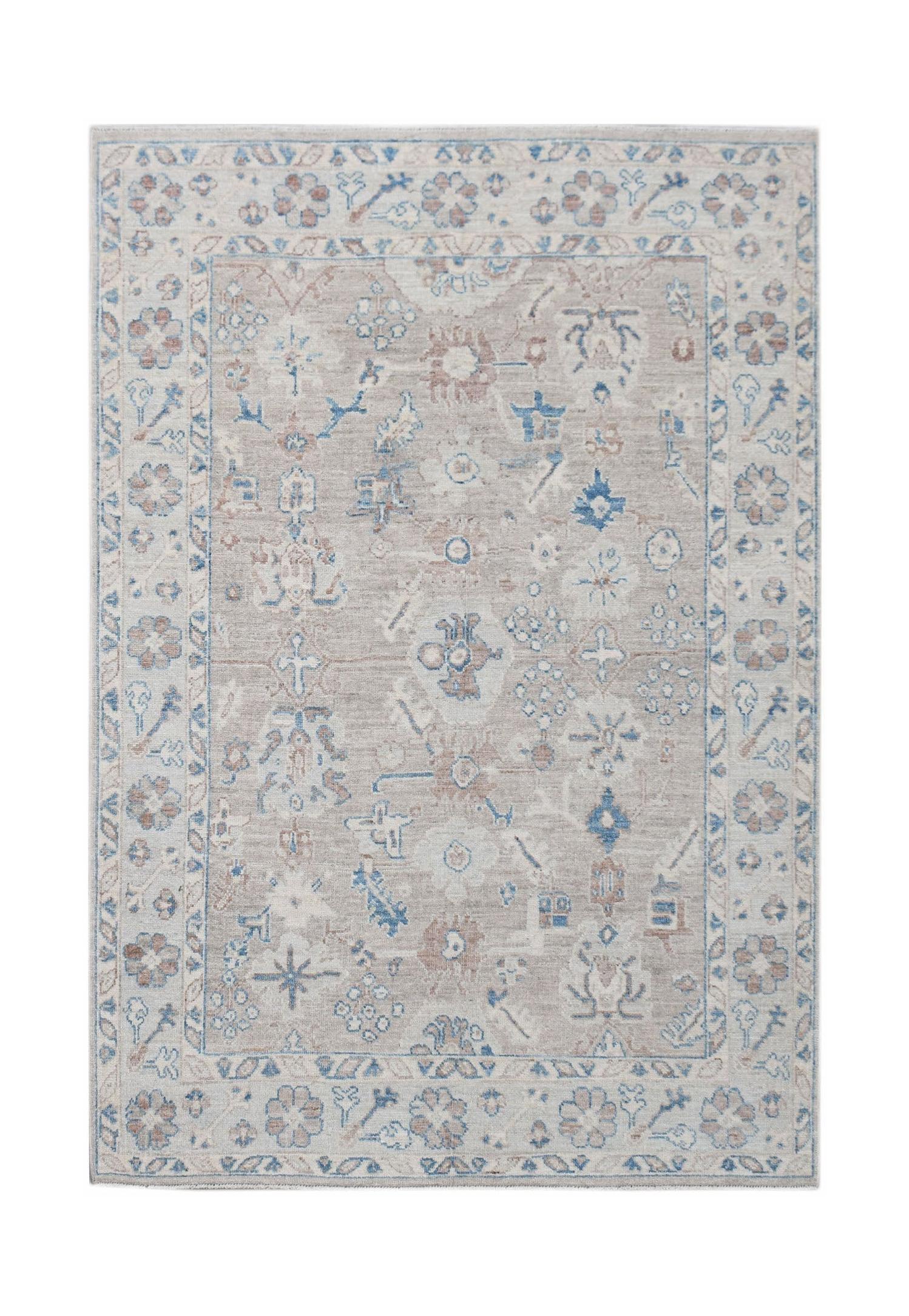 A handwoven transitional Oushak rug featuring a floral pattern in blue and tan on a beige field.