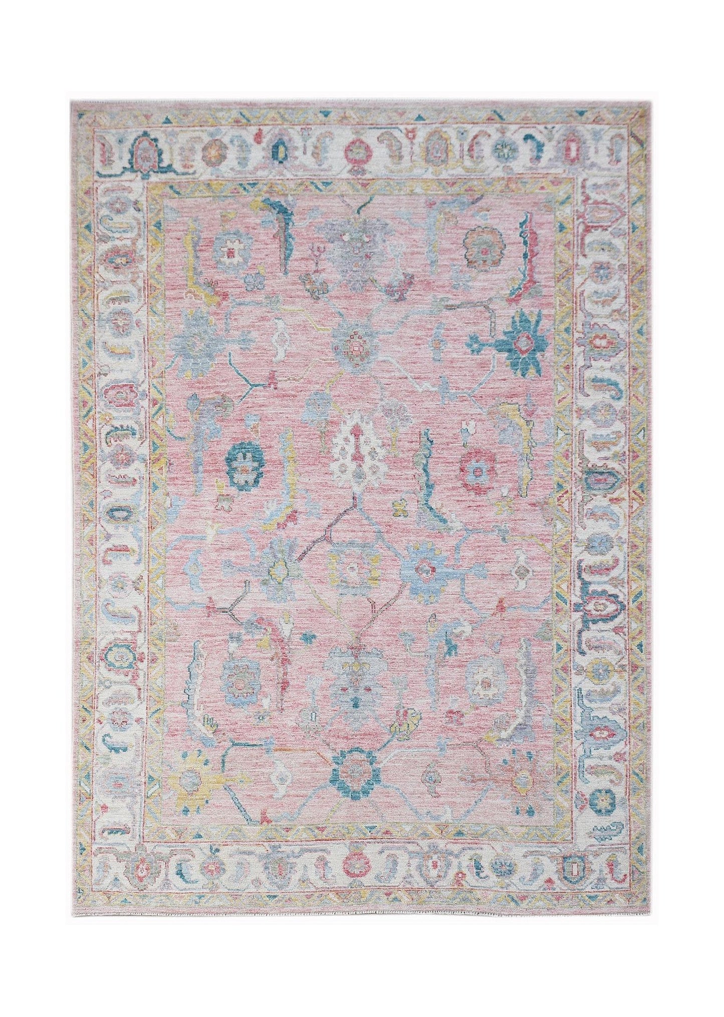 A handwoven transitional Oushak rug featuring a floral pattern in soft pink, blue, and yellow tones.