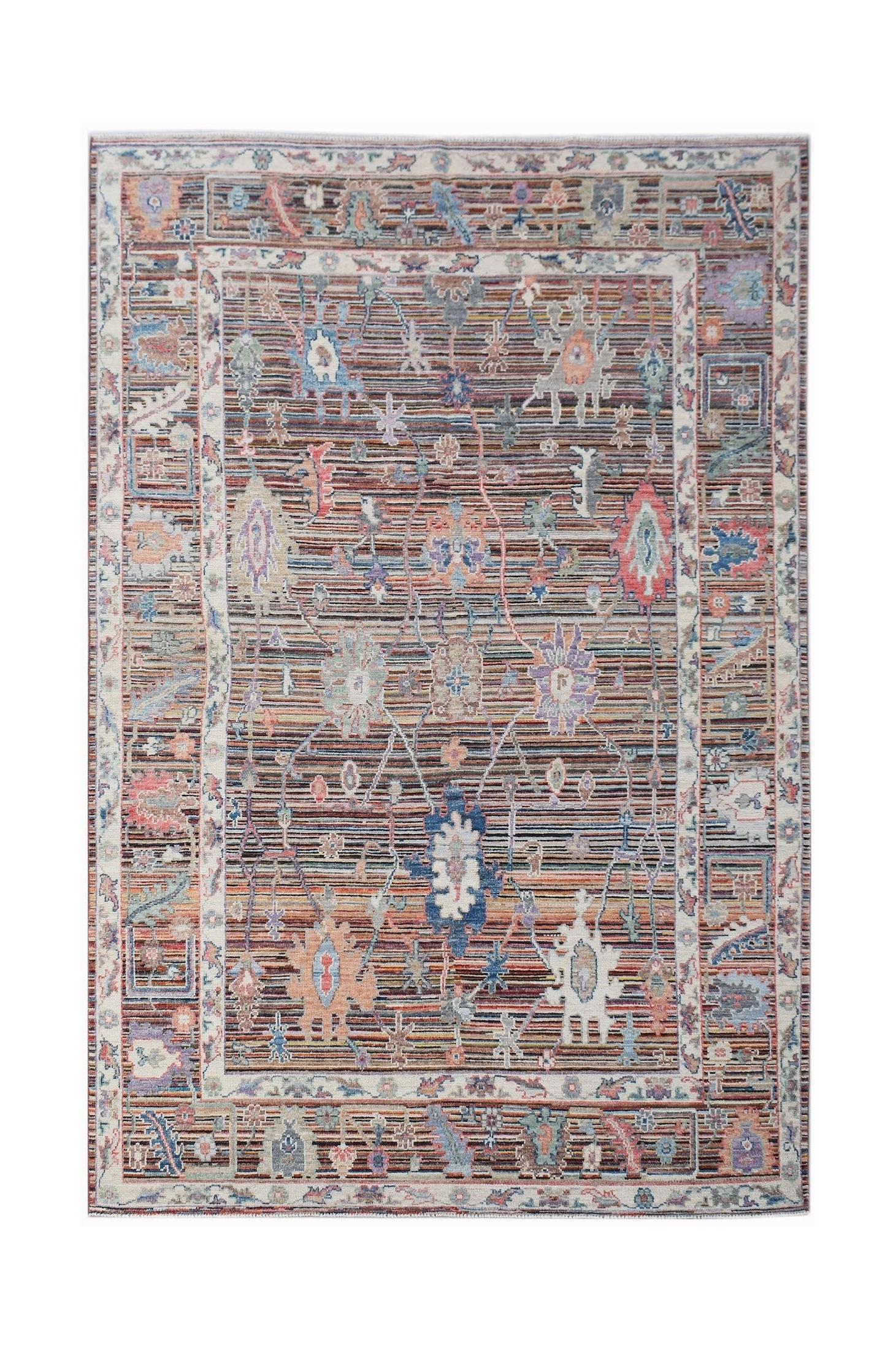 A handwoven transitional Oushak rug featuring a floral pattern in muted, contemporary colors.