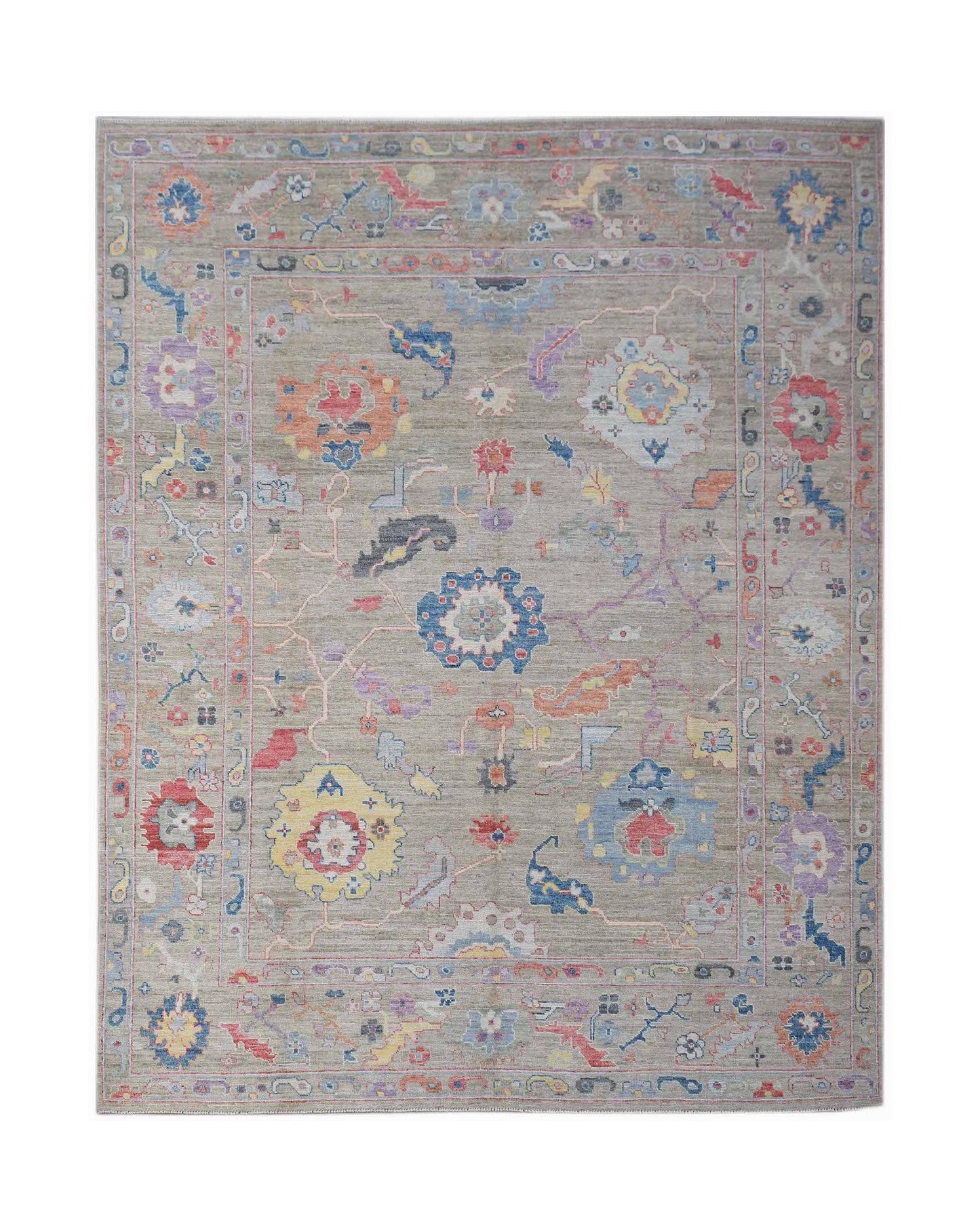 A handwoven transitional Oushak rug featuring a floral pattern in colorful tones on a gray field.