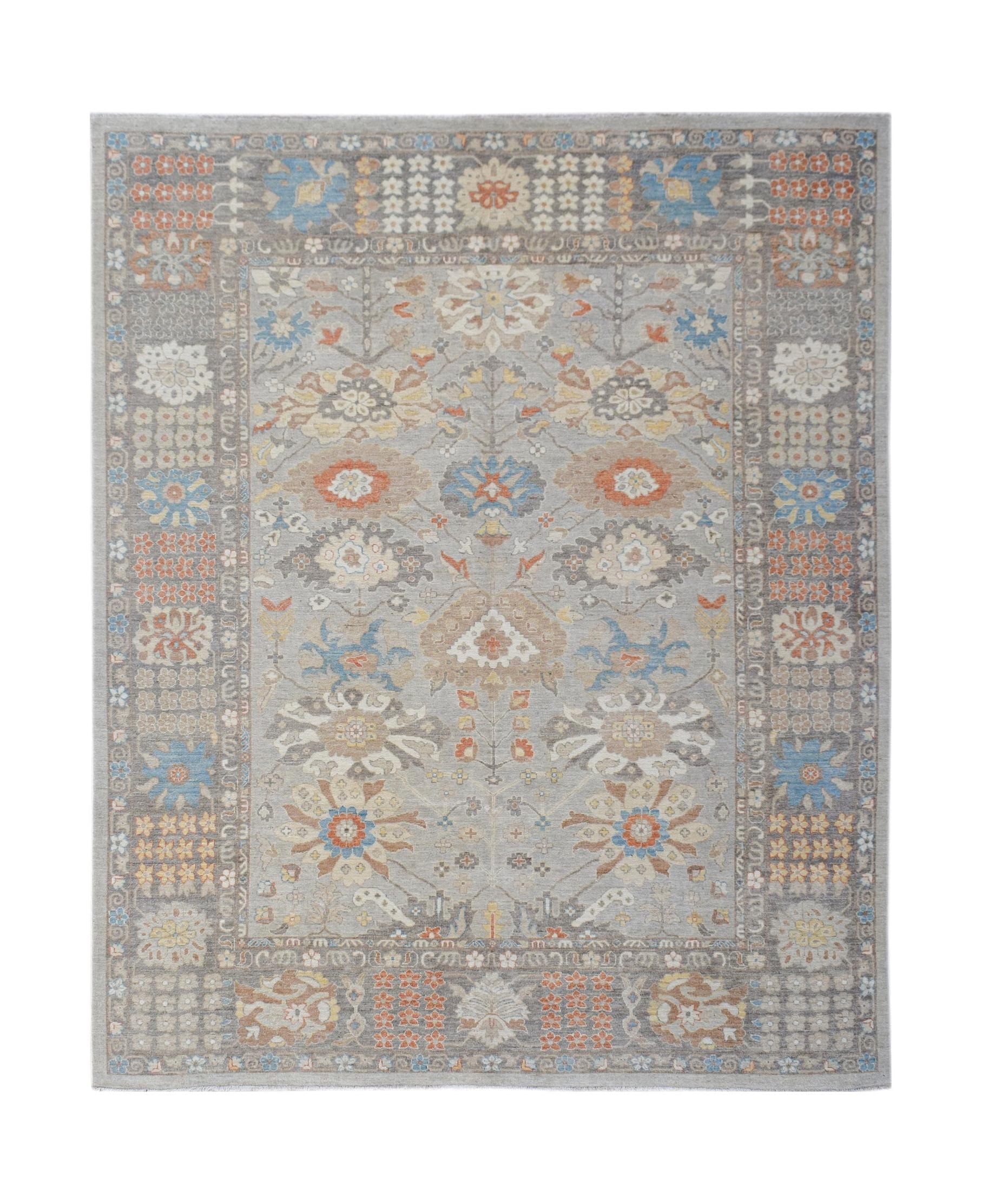 A handwoven transitional Oushak rug featuring a floral pattern in soft grey, blue, and orange tones.