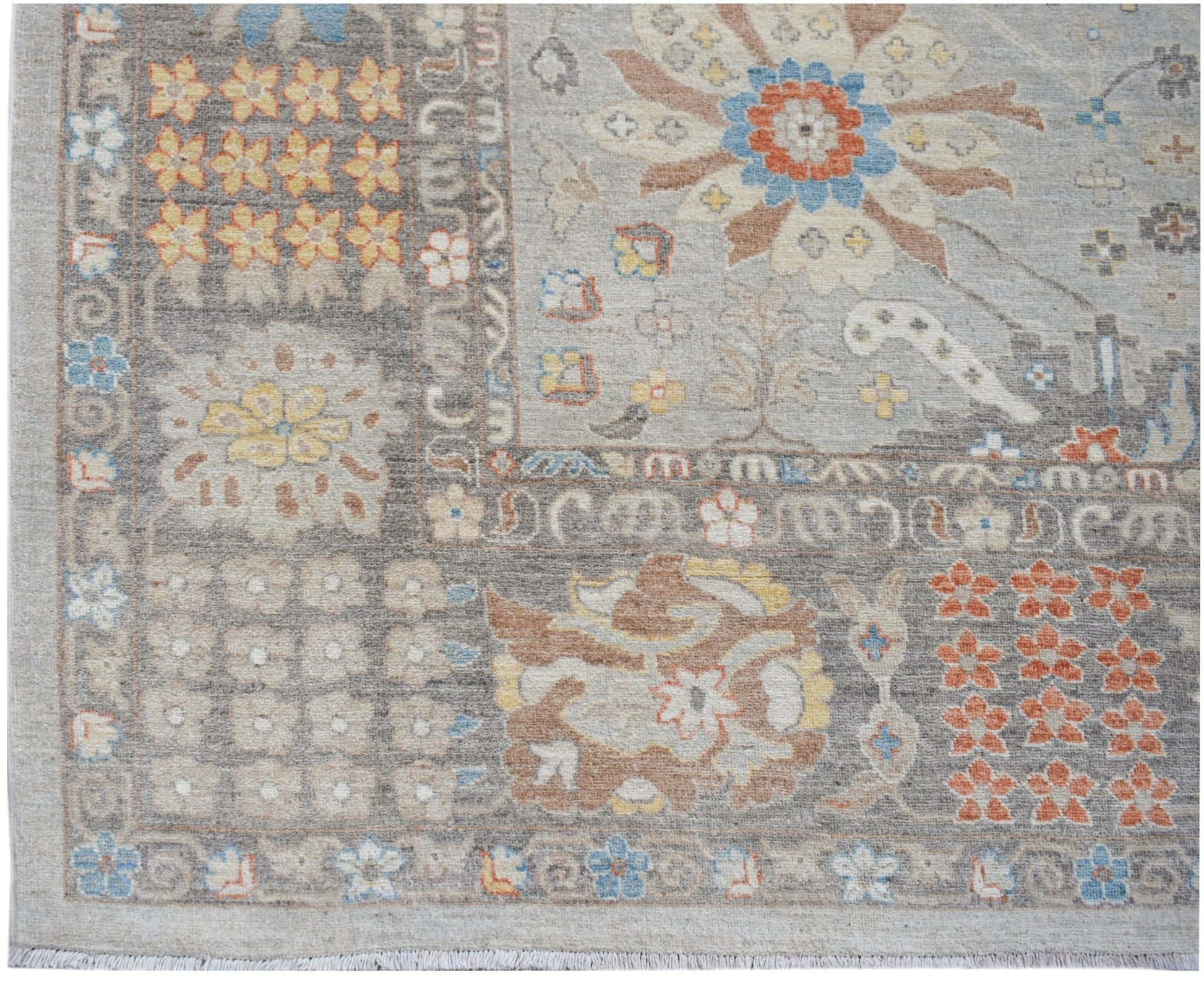 A transitional Oushak rug featuring a floral pattern in muted tones on a grey background.