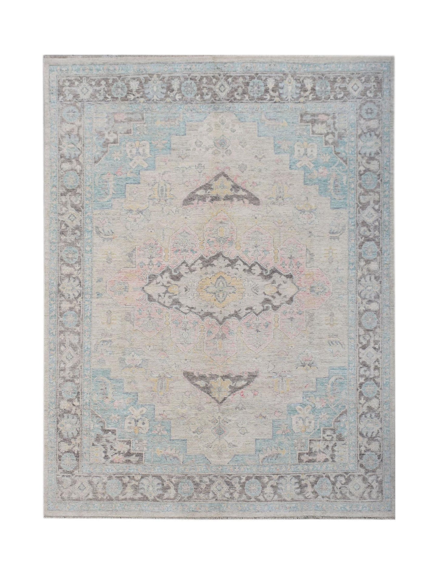 A handwoven transitional Oushak rug featuring a floral pattern in soft blue, pink, and grey tones.