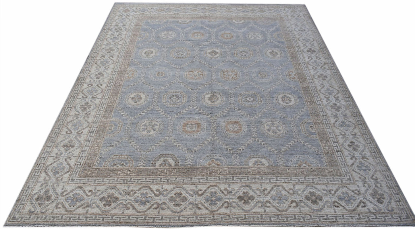 A handwoven transitional Oushak rug featuring a light blue field with a geometric floral pattern.