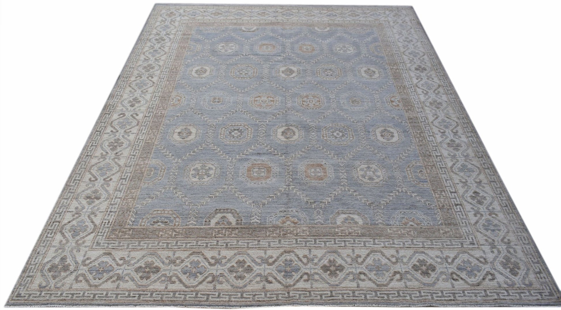A handwoven transitional Oushak rug featuring a light blue field with a geometric floral pattern.