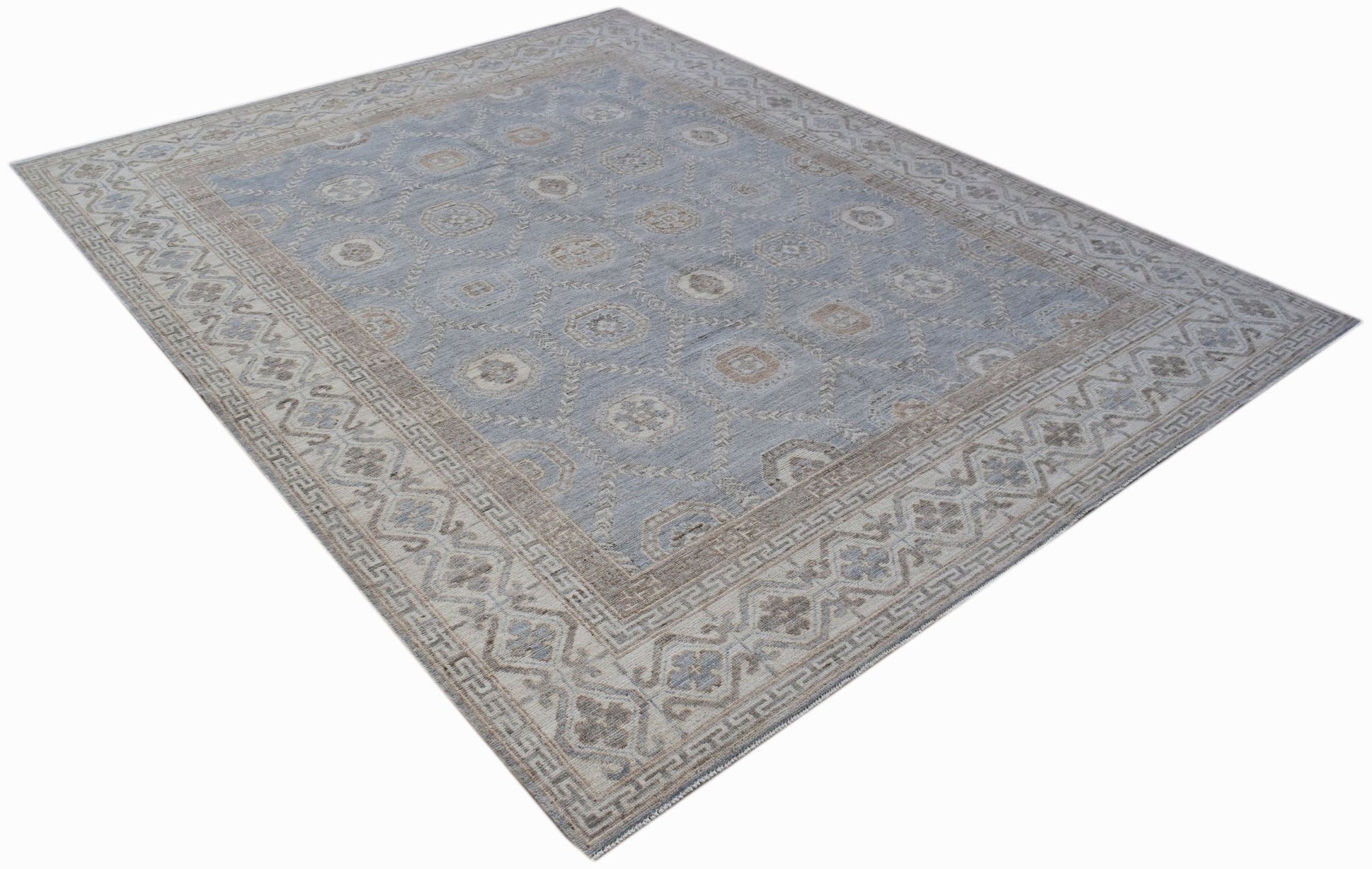 A handwoven transitional Oushak rug featuring a light blue field with a beige floral pattern.