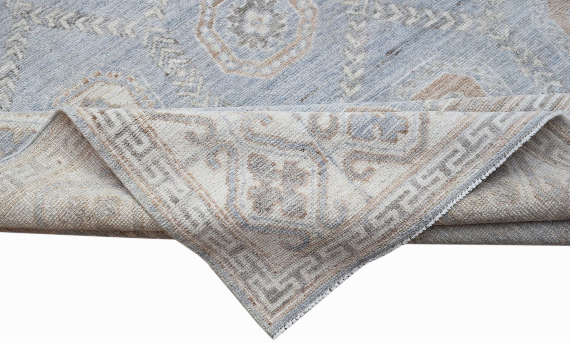 A handwoven transitional Oushak rug in light blue and beige with a traditional floral pattern.
