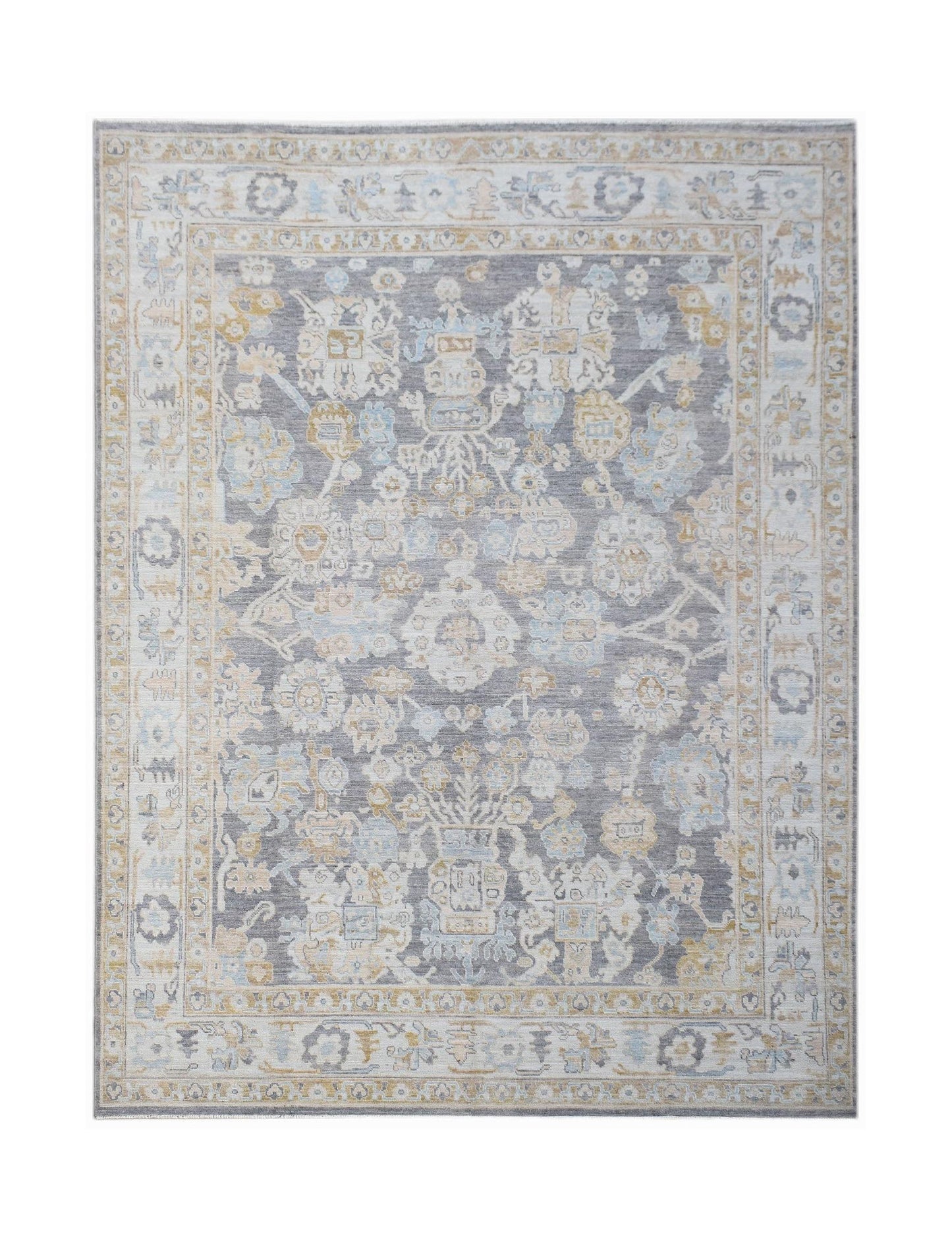 A handwoven transitional Oushak rug featuring a floral pattern in grey, blue, and gold tones.