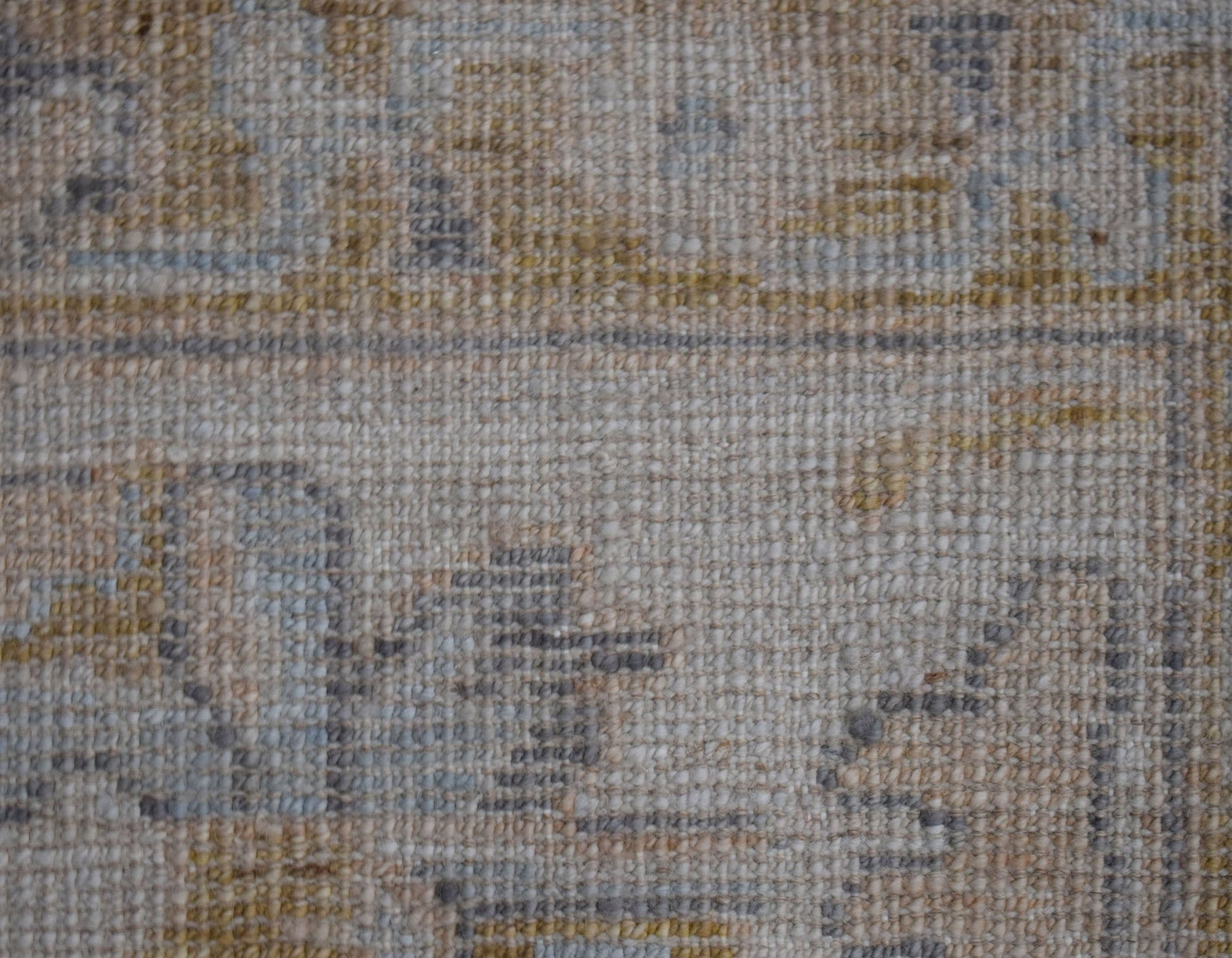 A close-up view of a handwoven transitional Oushak rug featuring a textured wool pile.