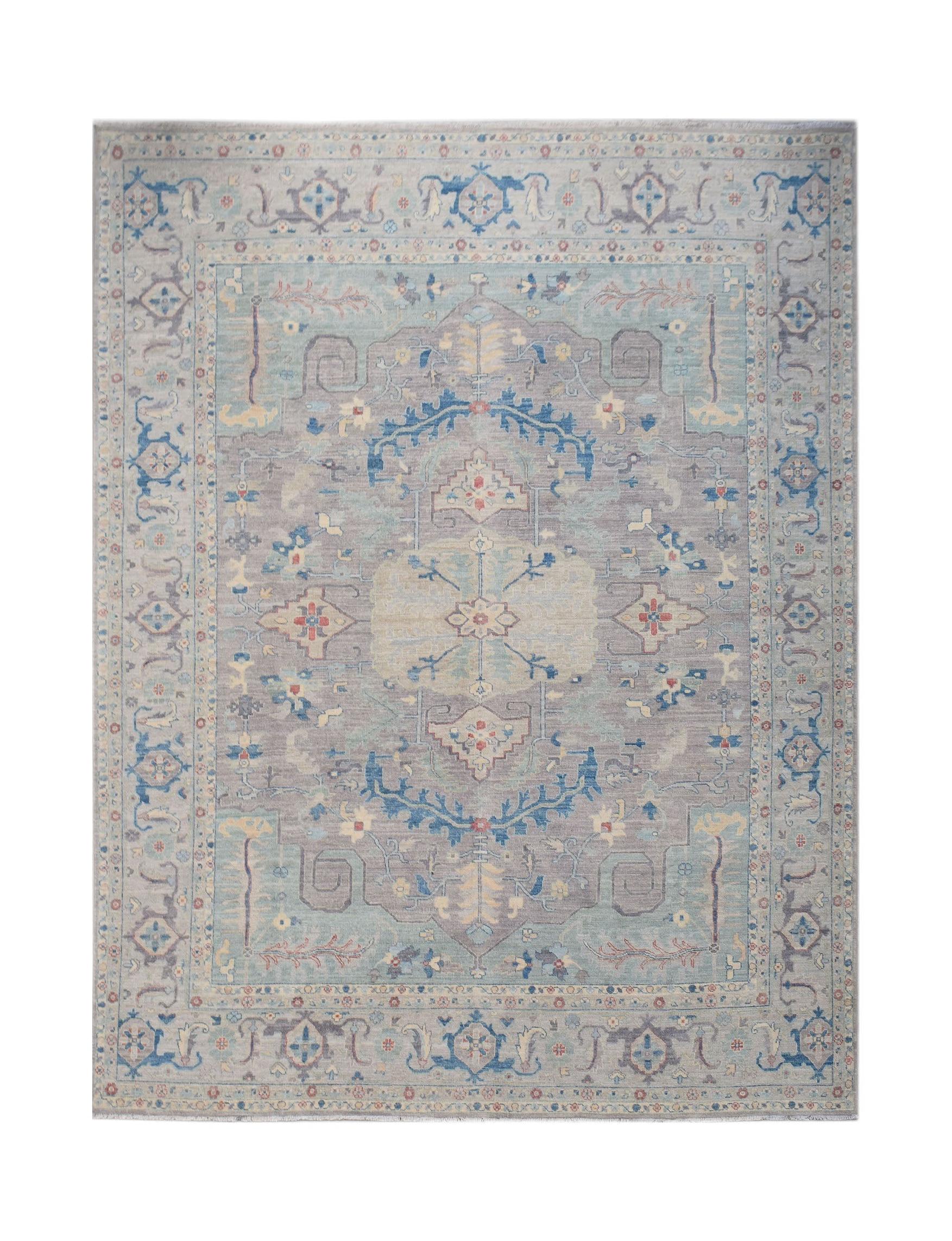 A handwoven transitional Oushak rug featuring a floral pattern in soft blue and grey tones.
