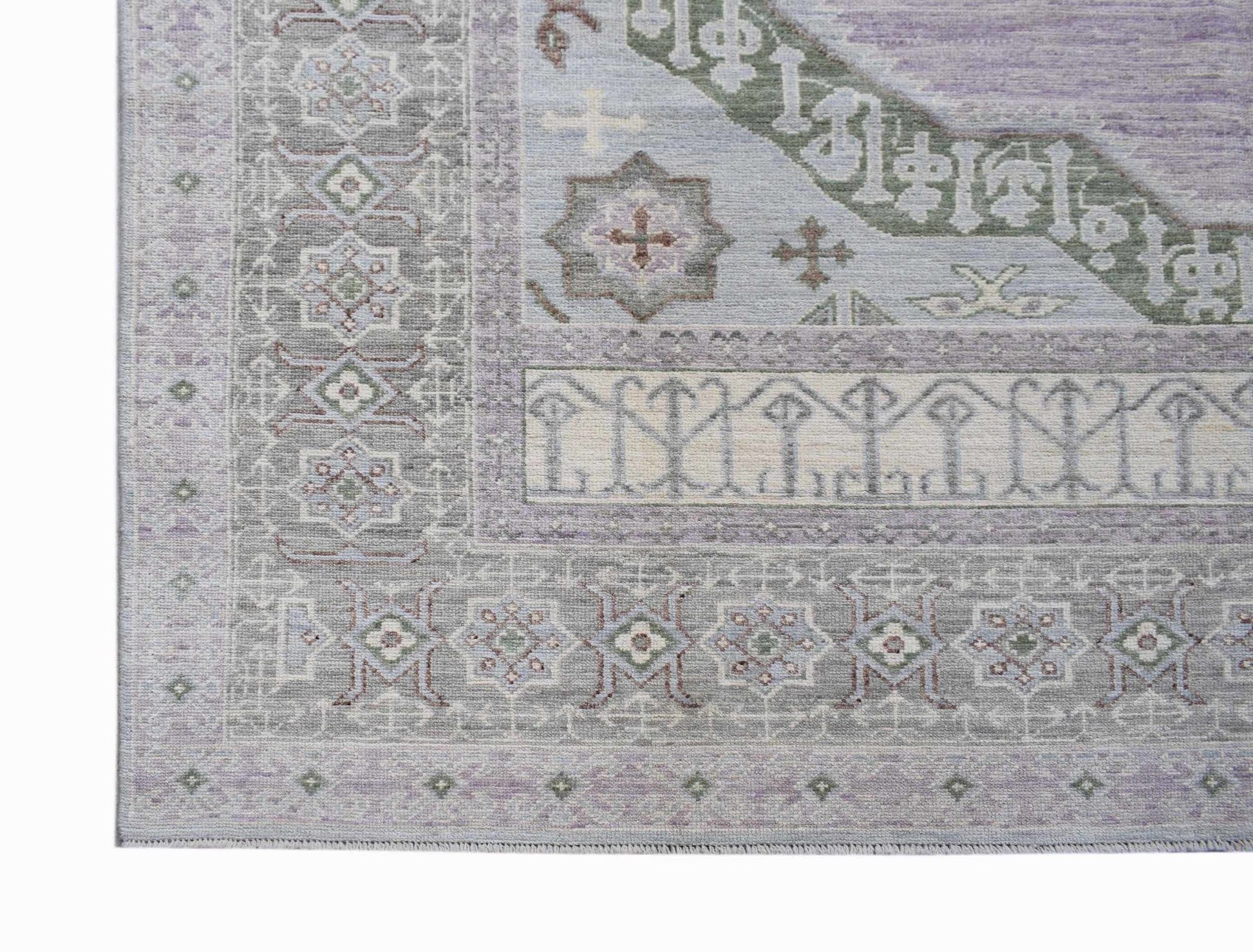 A handwoven transitional Oushak rug featuring a soft purple and grey floral pattern.