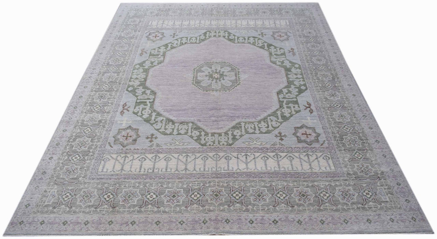 A handwoven transitional Oushak rug featuring a central medallion in soft lavender and sage green.