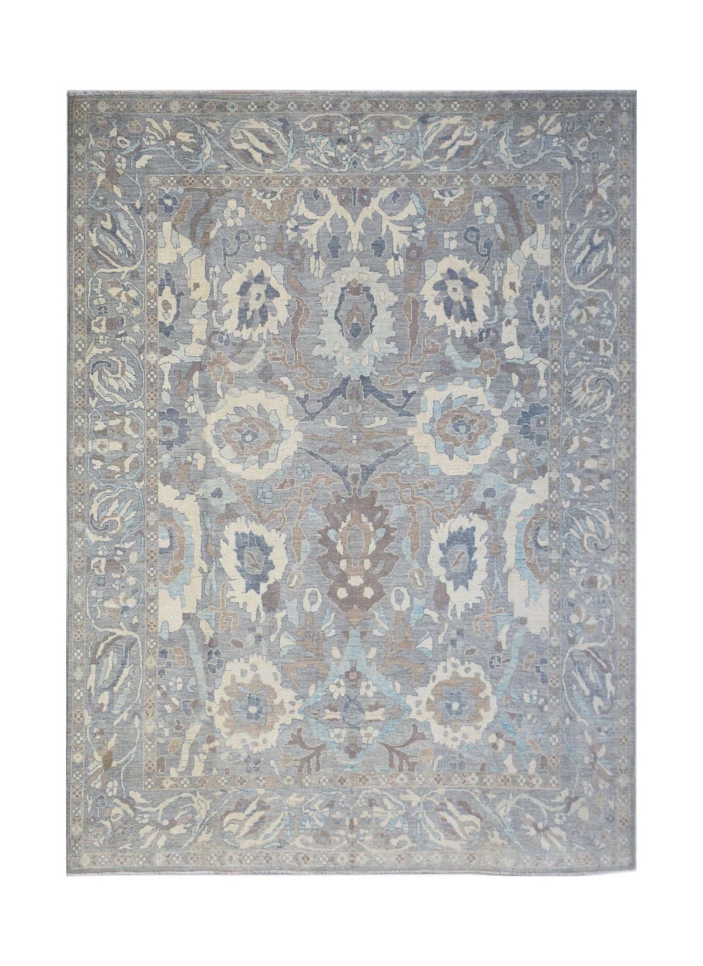 A handwoven transitional Oushak rug featuring a floral pattern in shades of blue, grey, and beige.