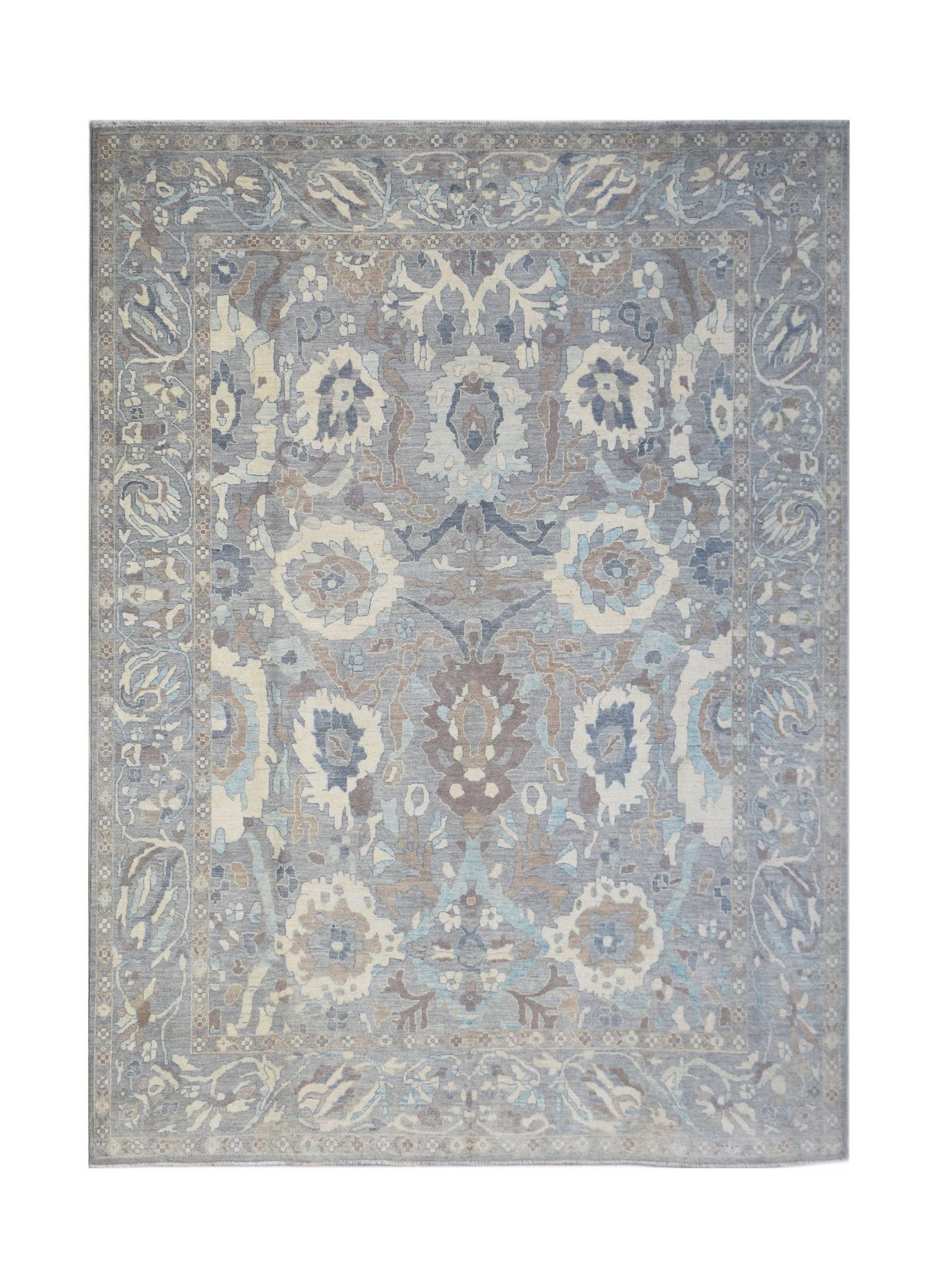 A handwoven transitional Oushak rug featuring a floral pattern in shades of blue, grey, and beige.