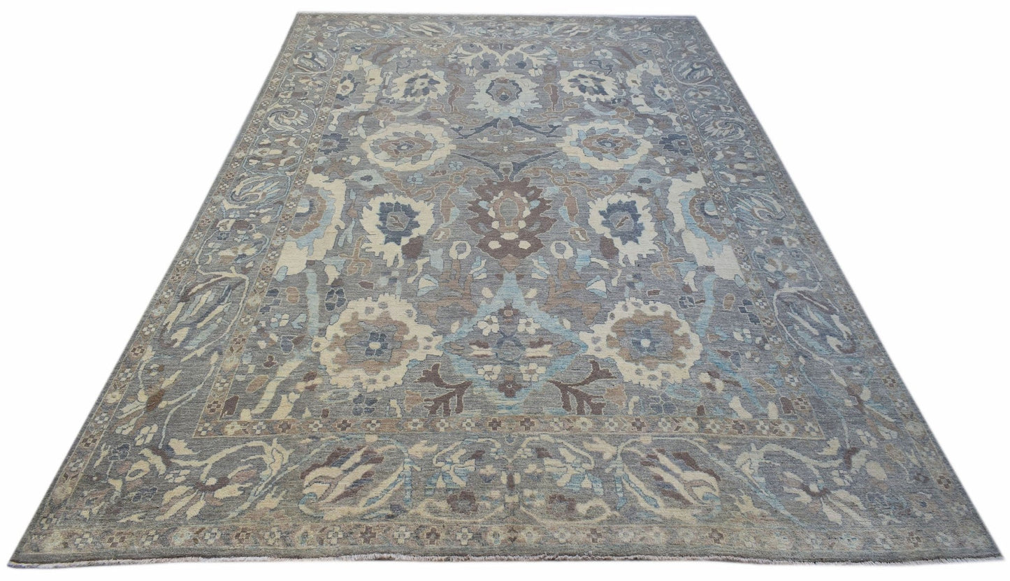 A handwoven transitional Oushak rug featuring a floral pattern in shades of blue, grey, and beige.