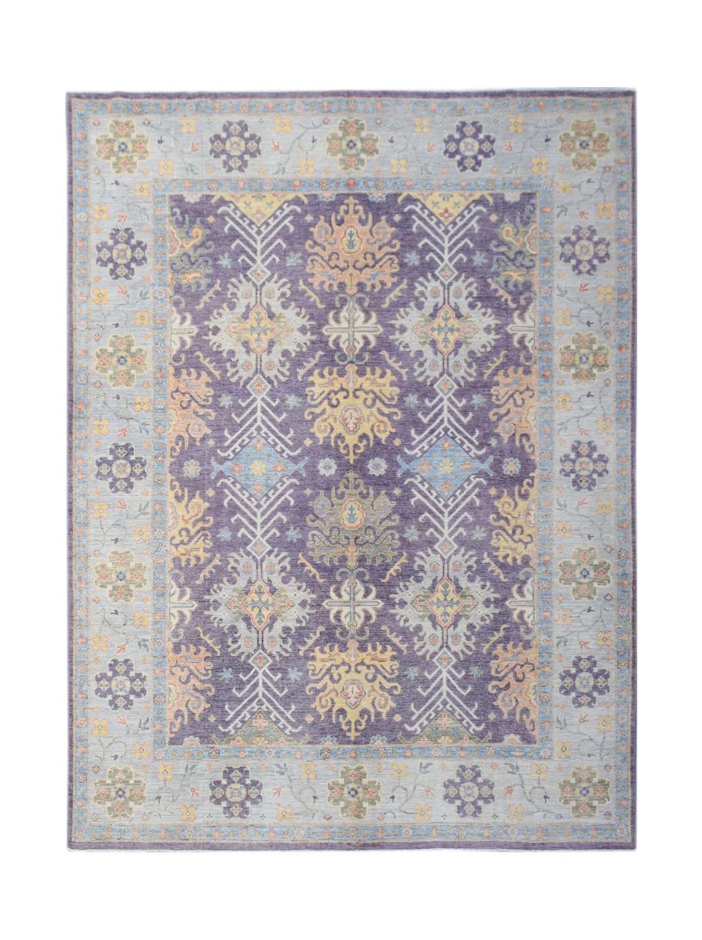 A handwoven transitional Oushak rug featuring a purple field with floral patterns and a blue border.