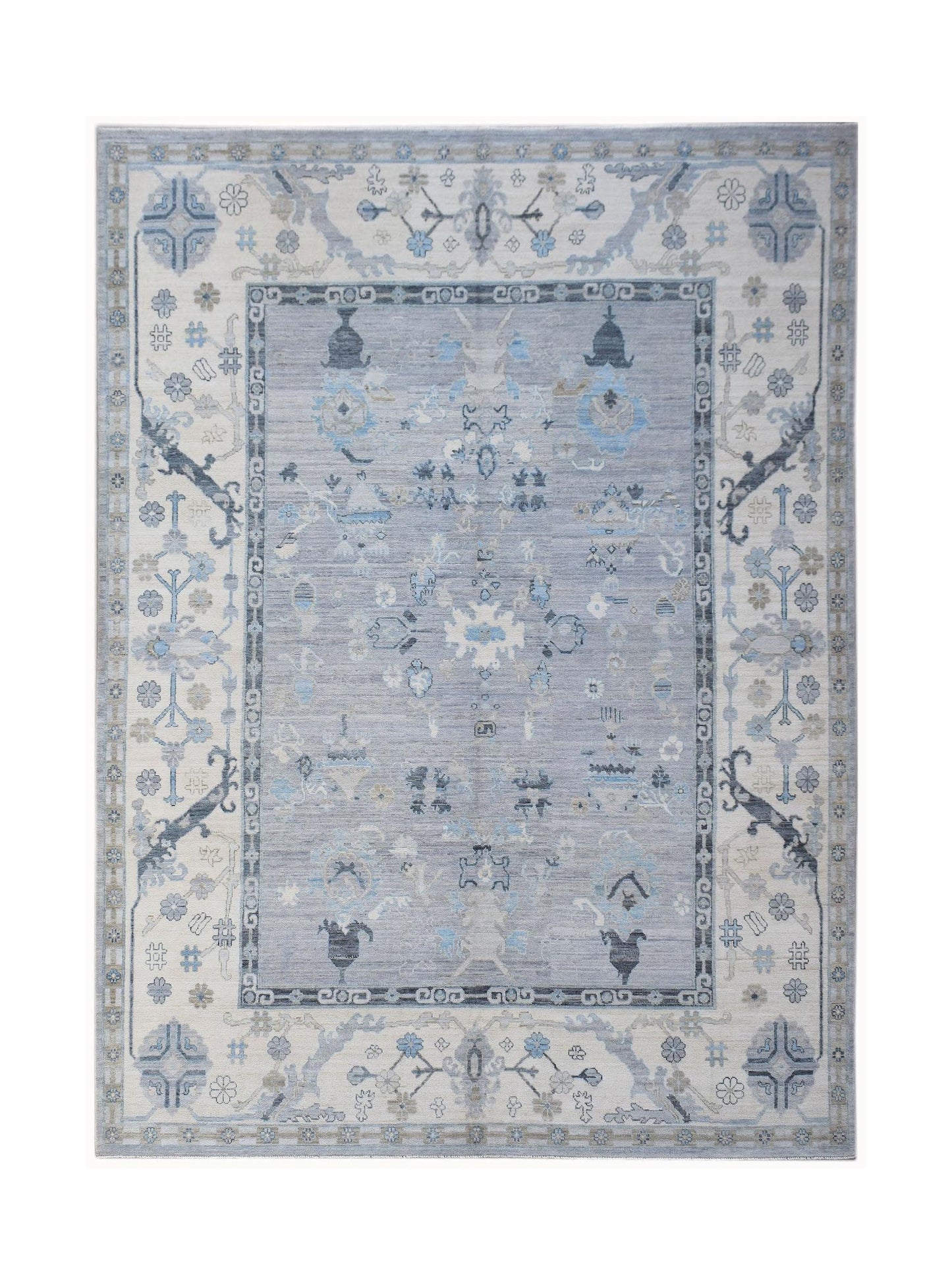 A handwoven transitional Oushak rug featuring a blue and cream floral pattern.
