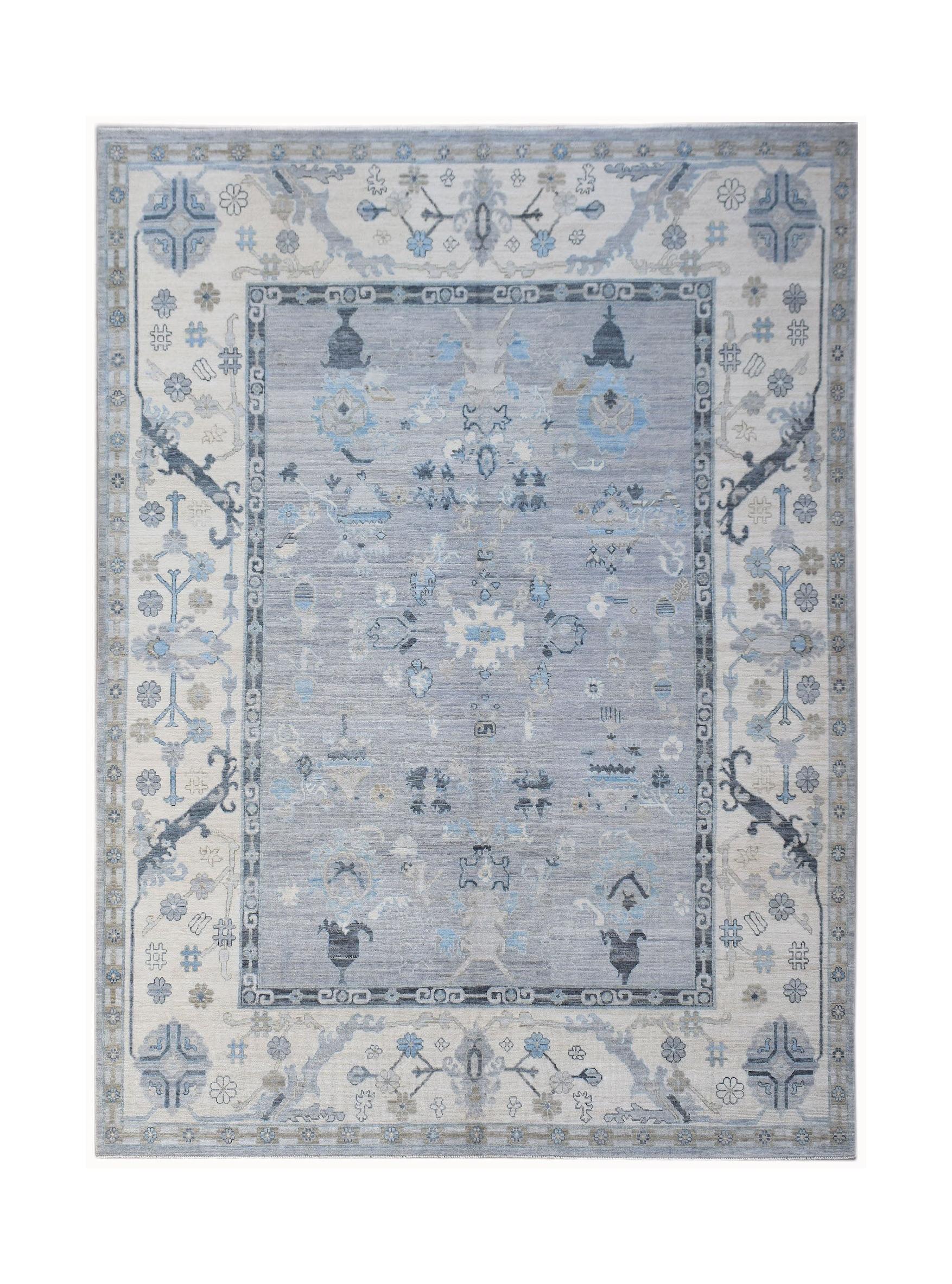 A handwoven transitional Oushak rug featuring a blue and cream floral pattern.