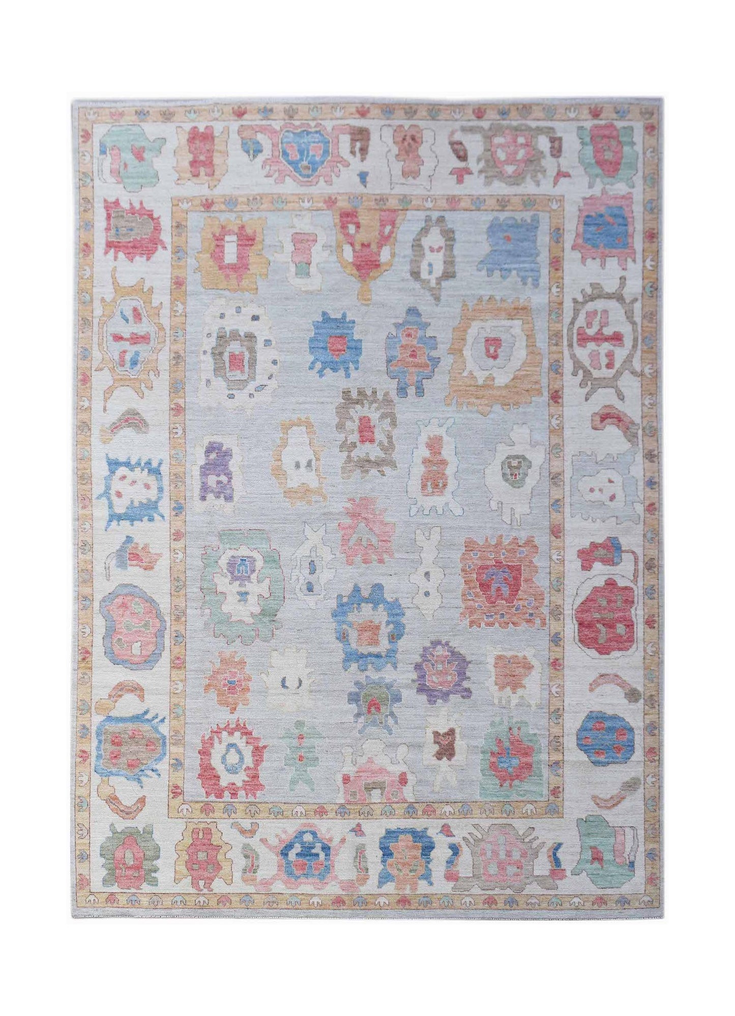 A handwoven transitional Oushak rug featuring a light blue field with colorful abstract motifs.