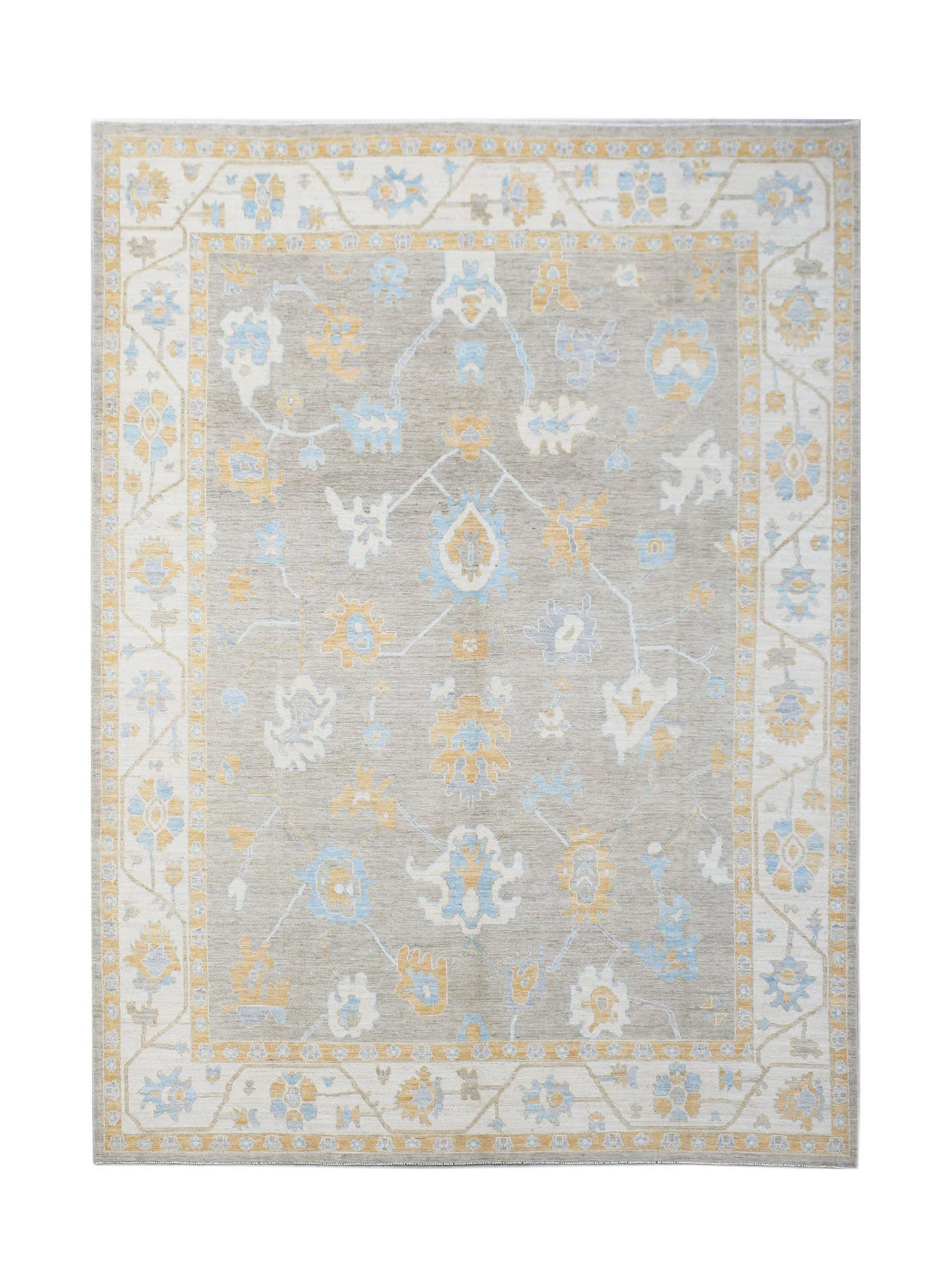 A transitional Oushak rug featuring a floral pattern in soft blue and yellow on a grey background.