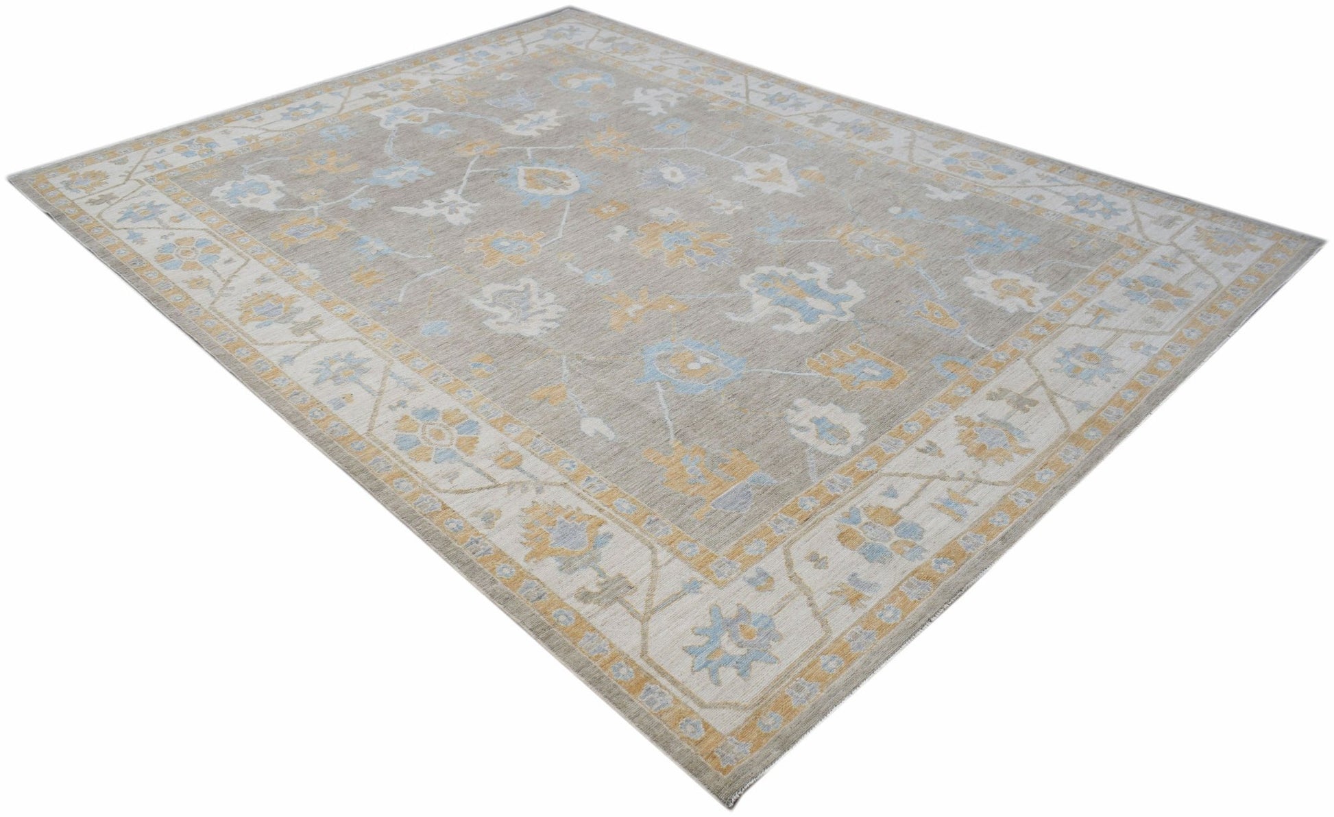 A handwoven transitional Oushak rug featuring a floral pattern in soft blue and yellow tones.