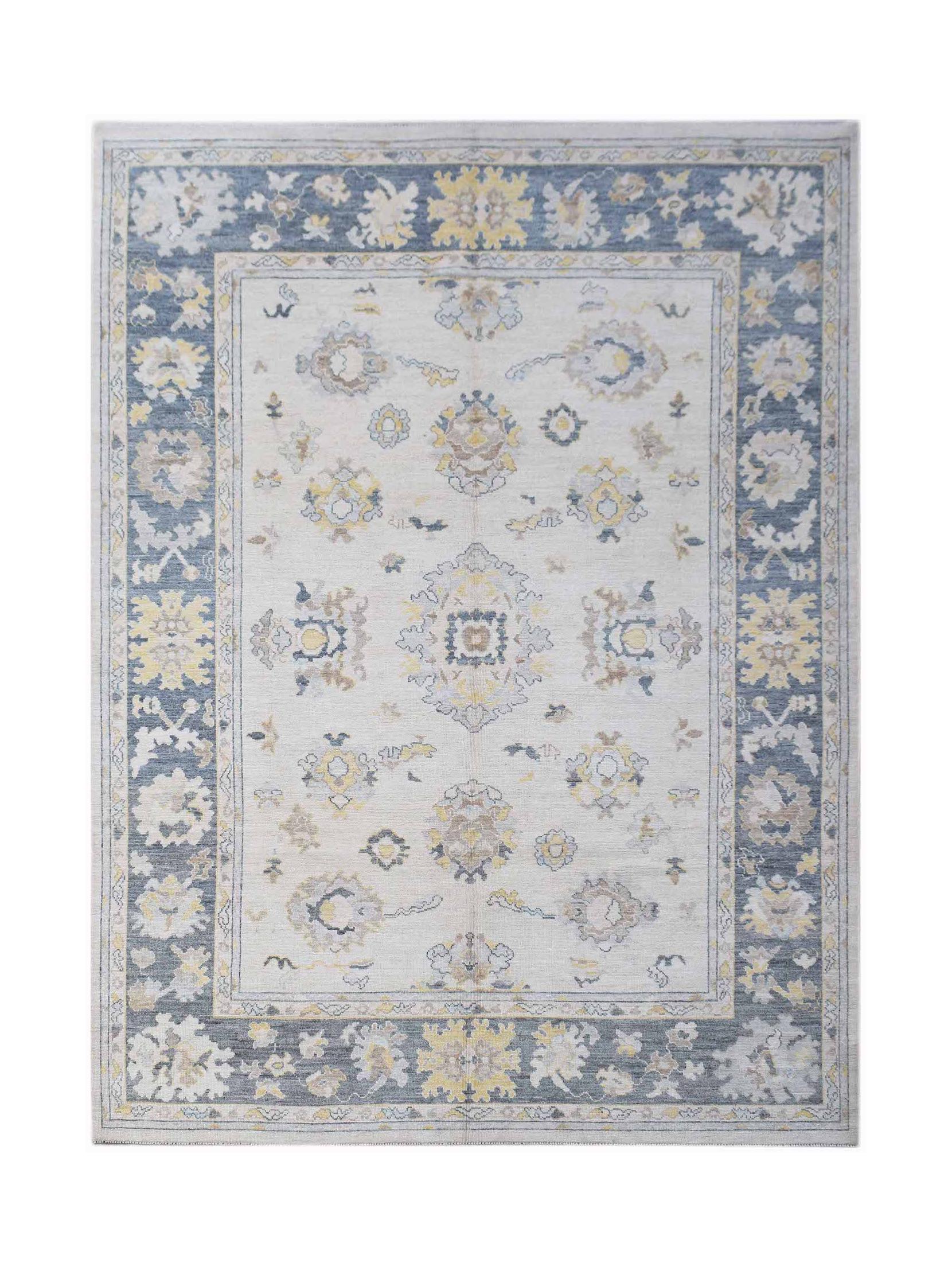 A handwoven transitional Oushak rug featuring a floral pattern in blue, yellow, and cream tones.