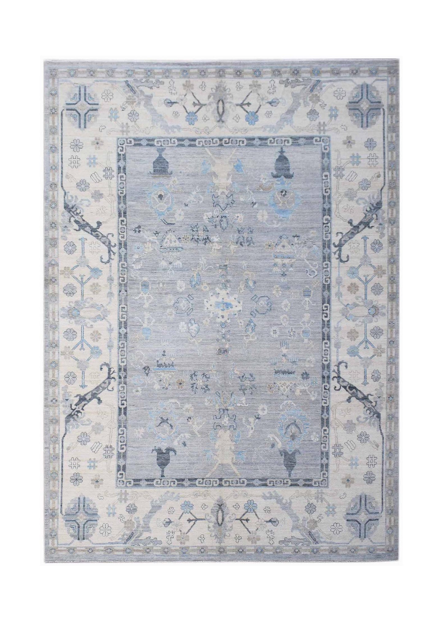 A handwoven transitional Oushak rug featuring a floral pattern in shades of blue and cream.