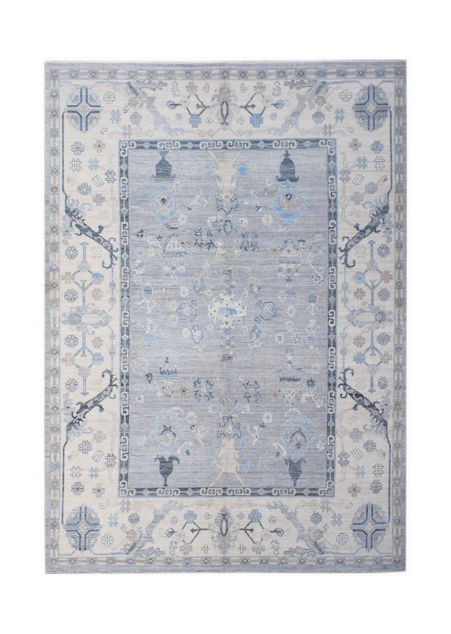 A handwoven transitional Oushak rug featuring a floral pattern in shades of blue and cream.