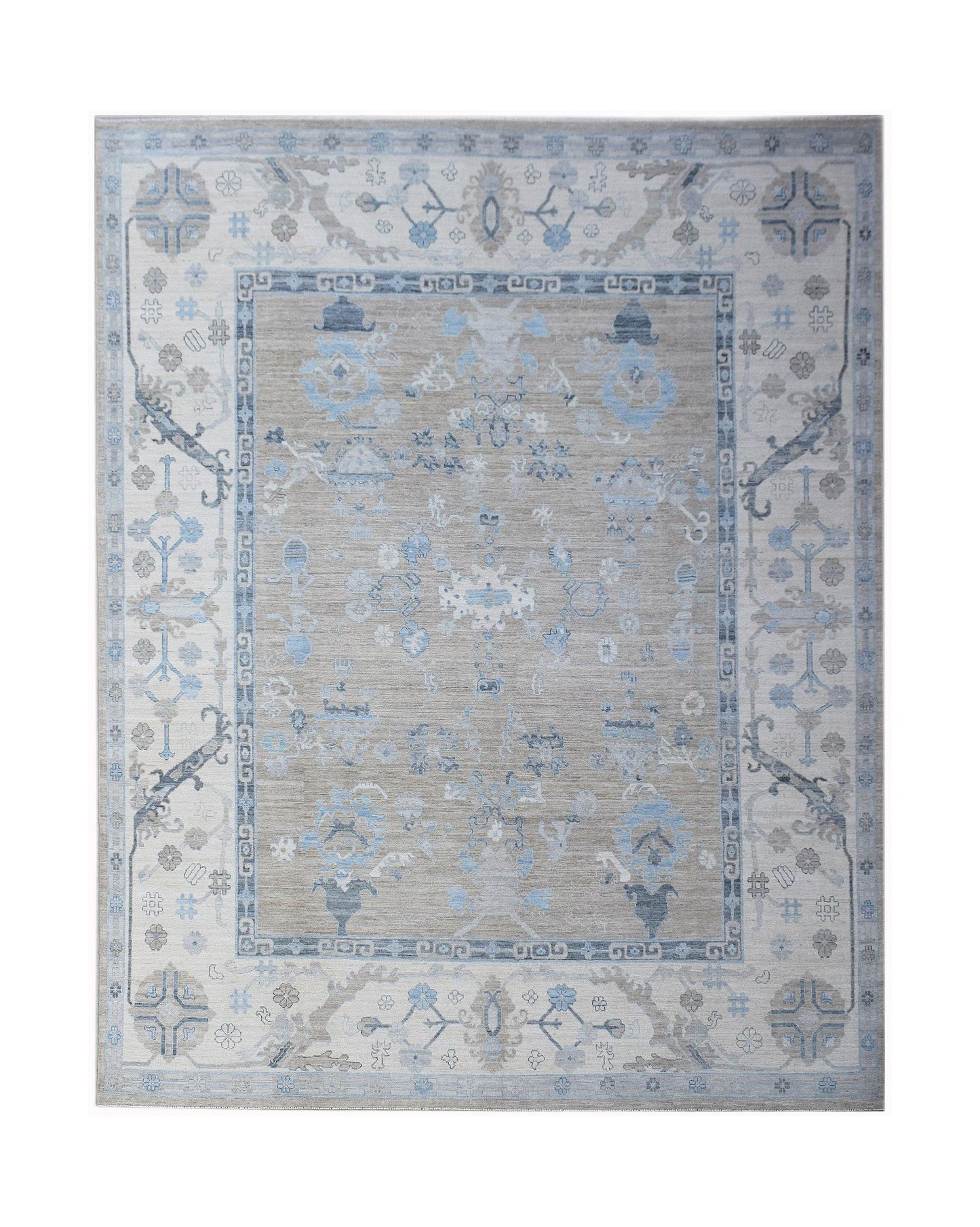 A handwoven transitional Oushak rug featuring a floral pattern in shades of blue, grey, and beige.