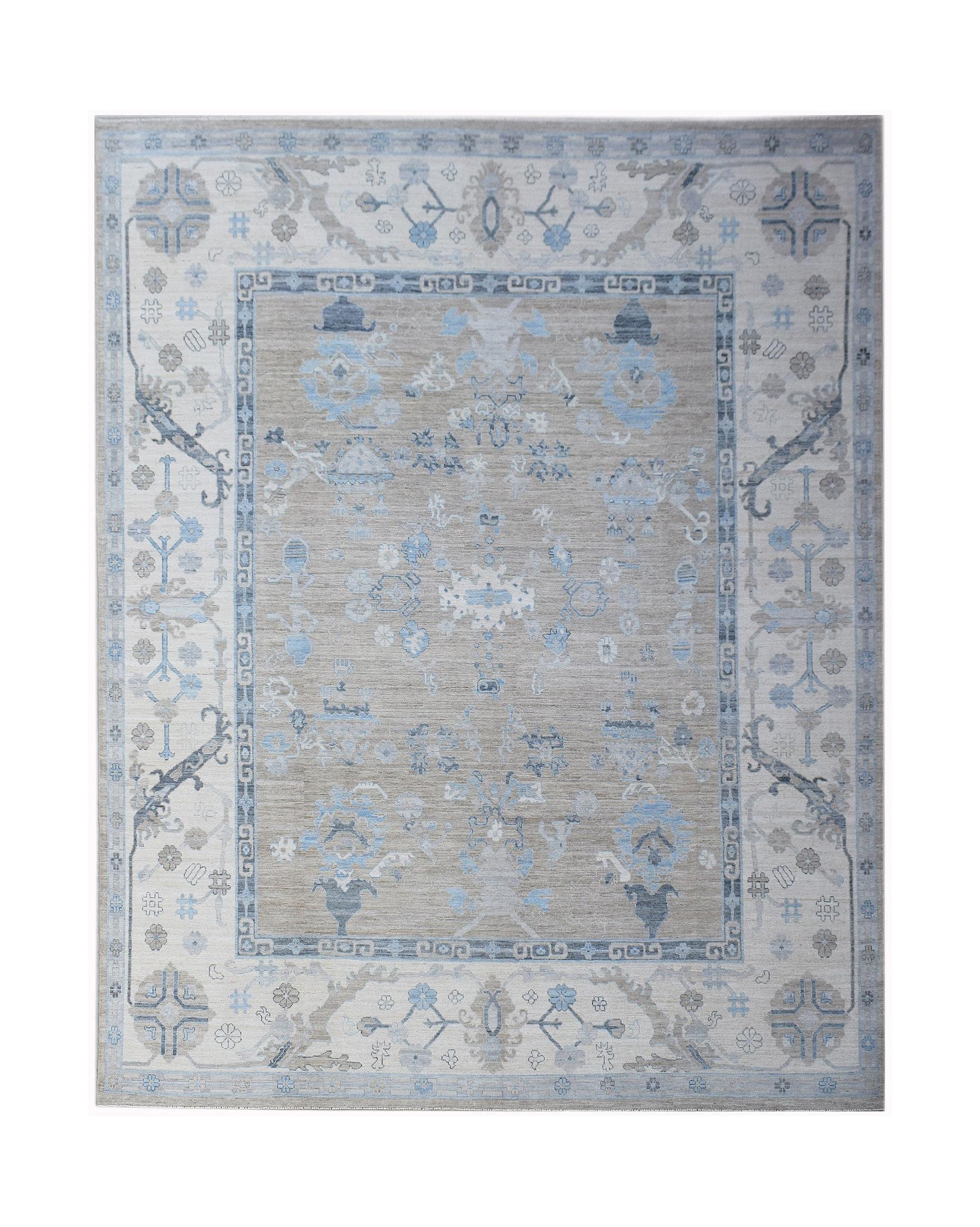 A handwoven transitional Oushak rug featuring a floral pattern in shades of blue, grey, and beige.