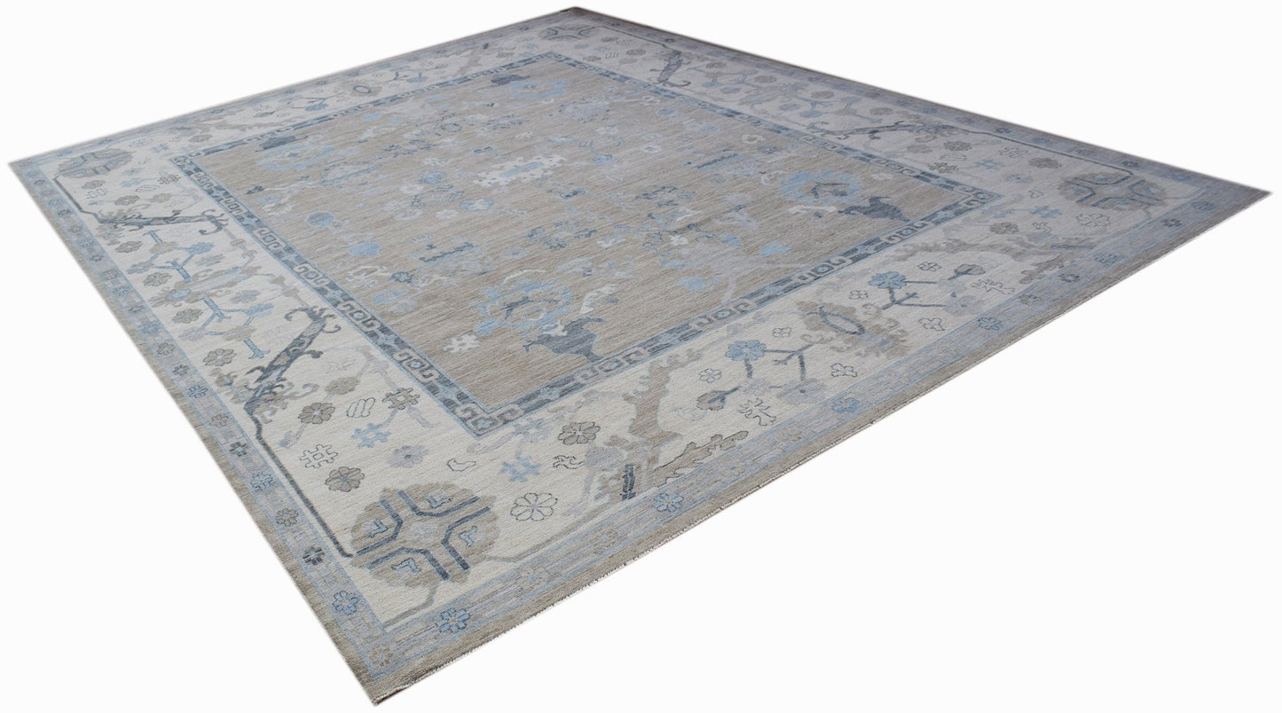 A handwoven transitional Oushak rug featuring a floral pattern in soft blue and beige tones.