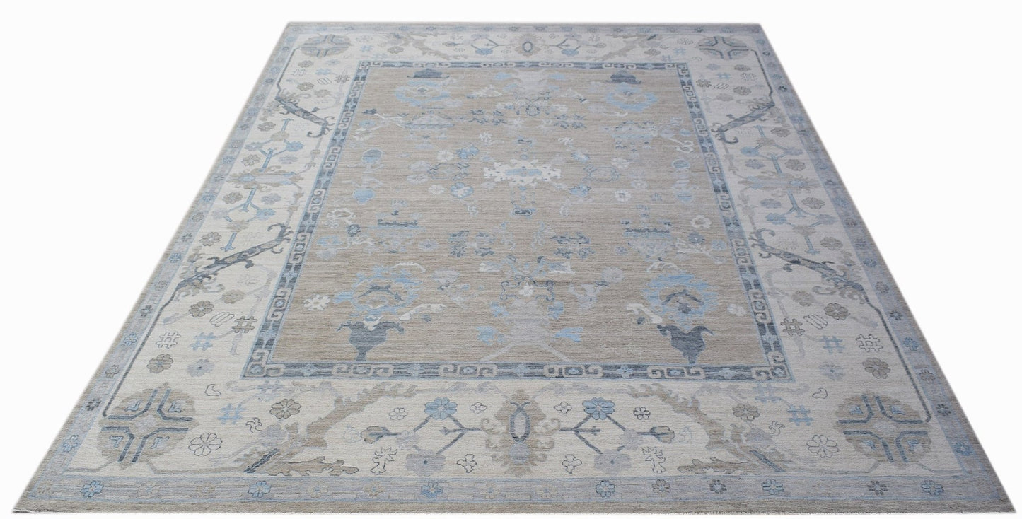 A handwoven transitional Oushak rug featuring a floral pattern in shades of blue and beige.