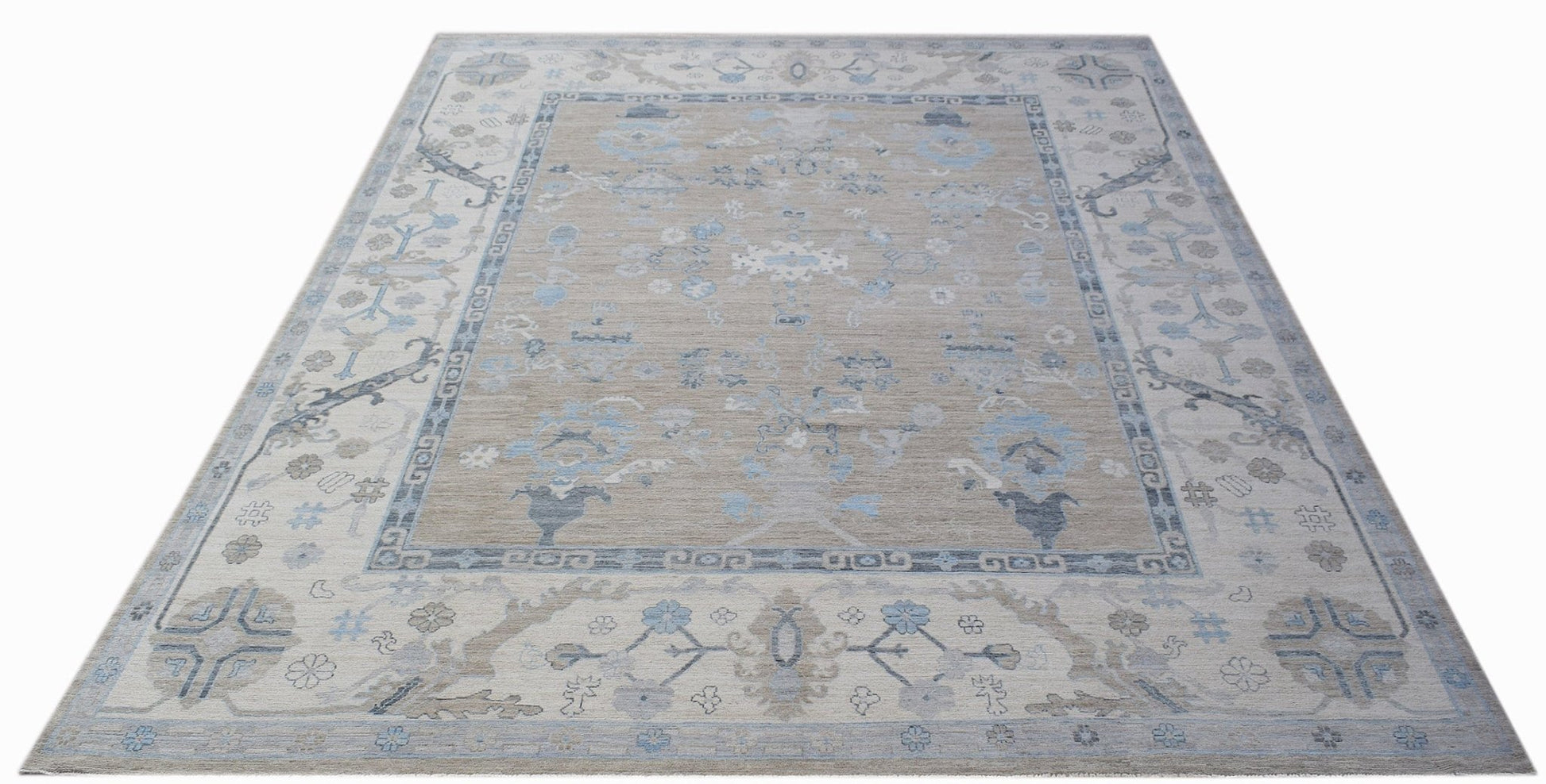 A handwoven transitional Oushak rug featuring a floral pattern in shades of blue and beige.