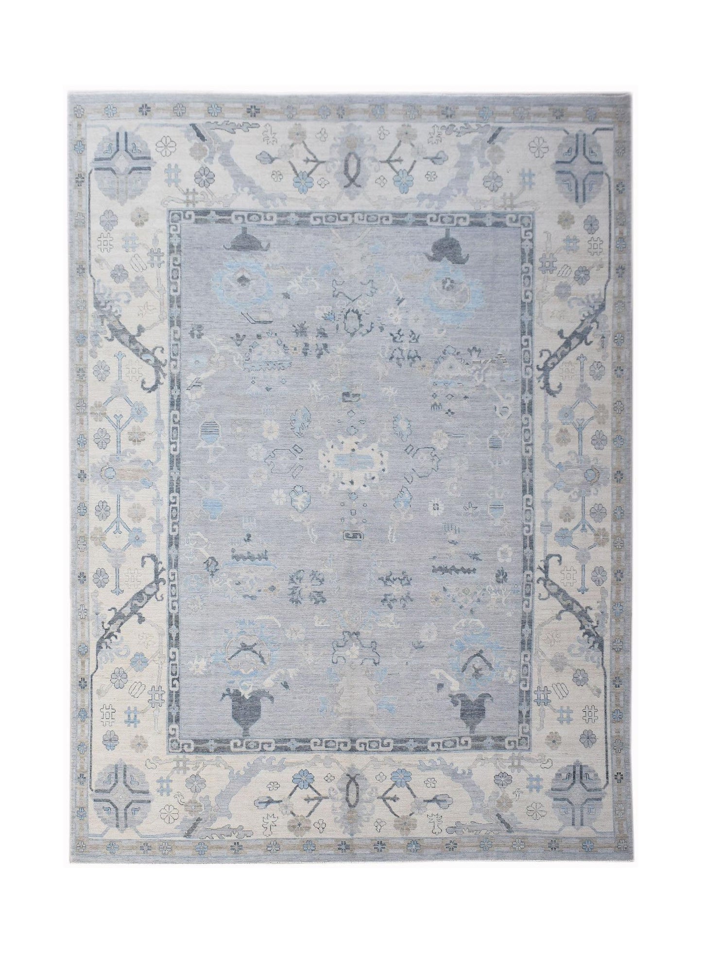 A handwoven transitional Oushak rug featuring a light blue floral pattern on a cream background.