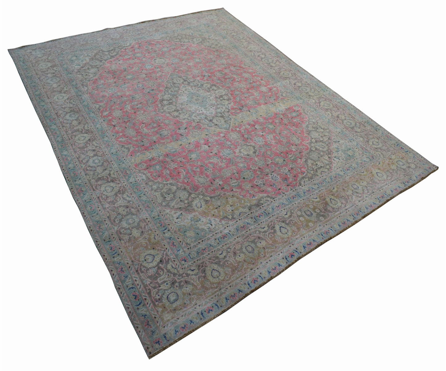 A vintage handwoven Persian Kashan rug featuring a large pink central medallion and floral motifs.
