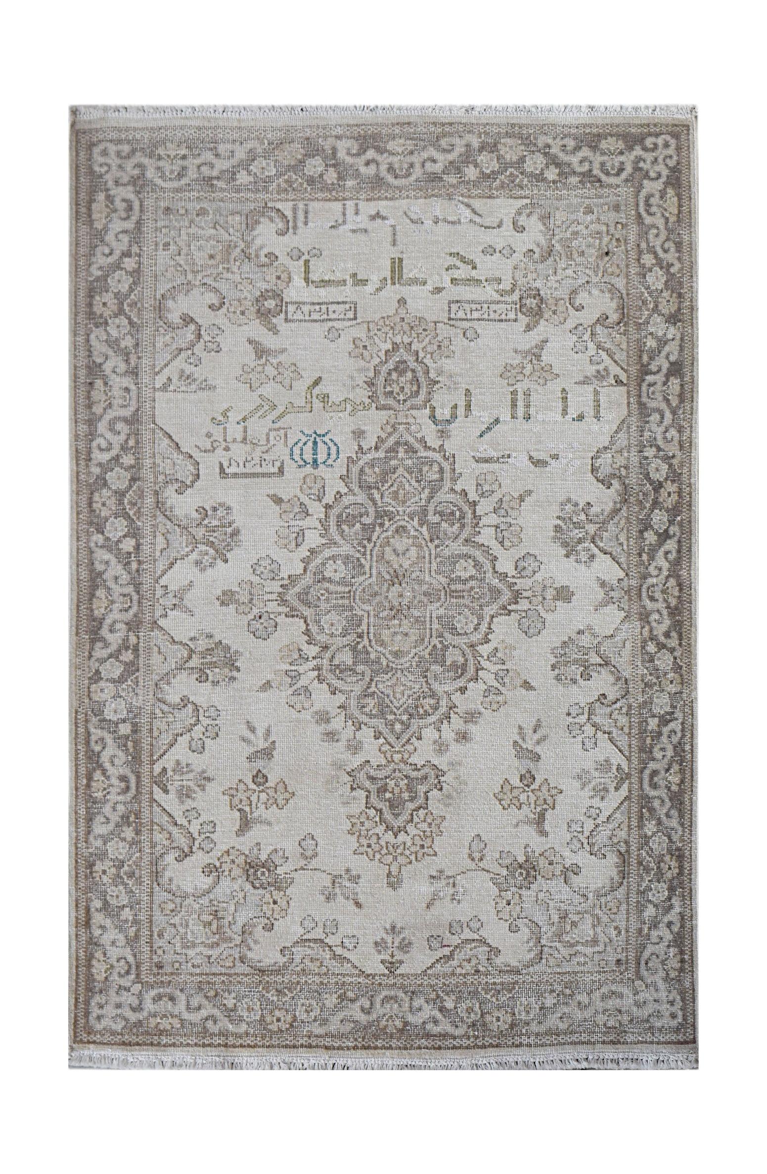 A vintage Persian Kerman rug featuring a central medallion and intricate floral motifs in neutral tones.