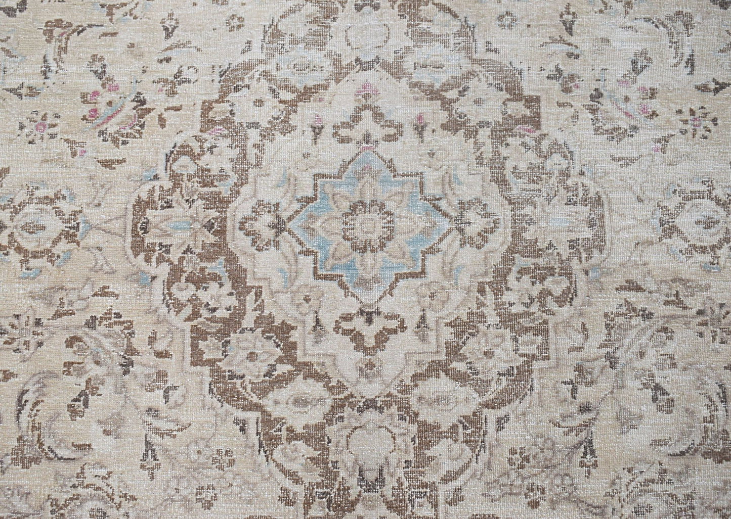 A vintage Persian Kerman rug featuring a central medallion with intricate floral patterns.