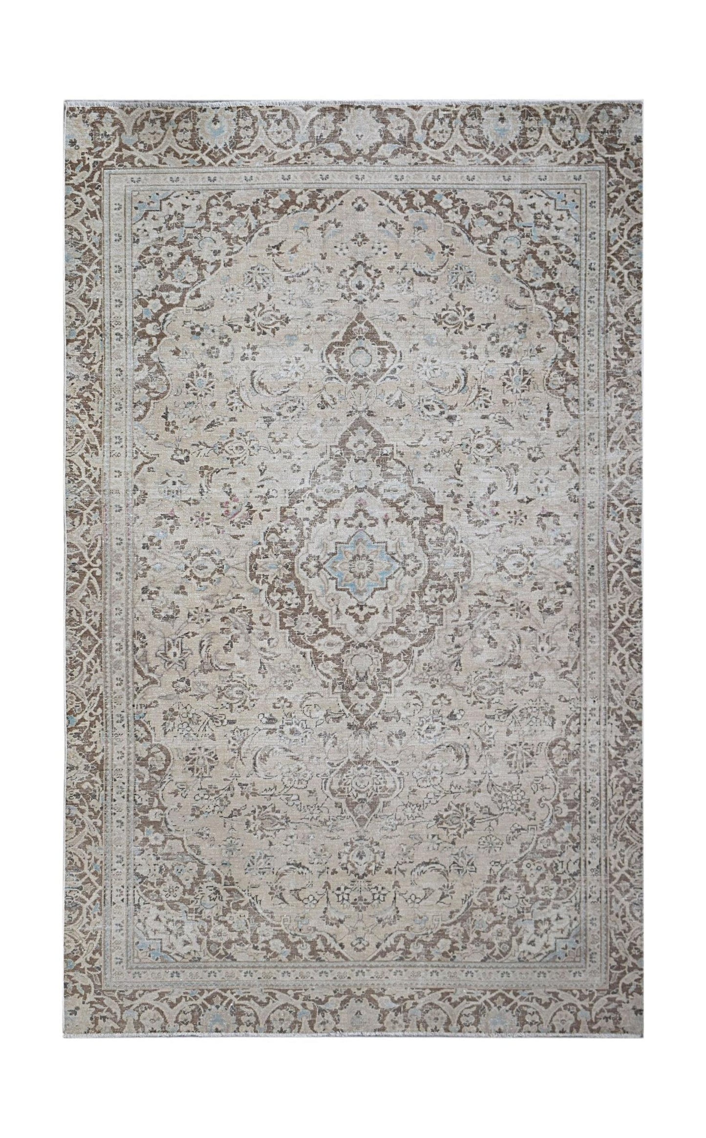 A vintage Persian Kerman rug featuring an intricate floral medallion in soft brown and beige tones.