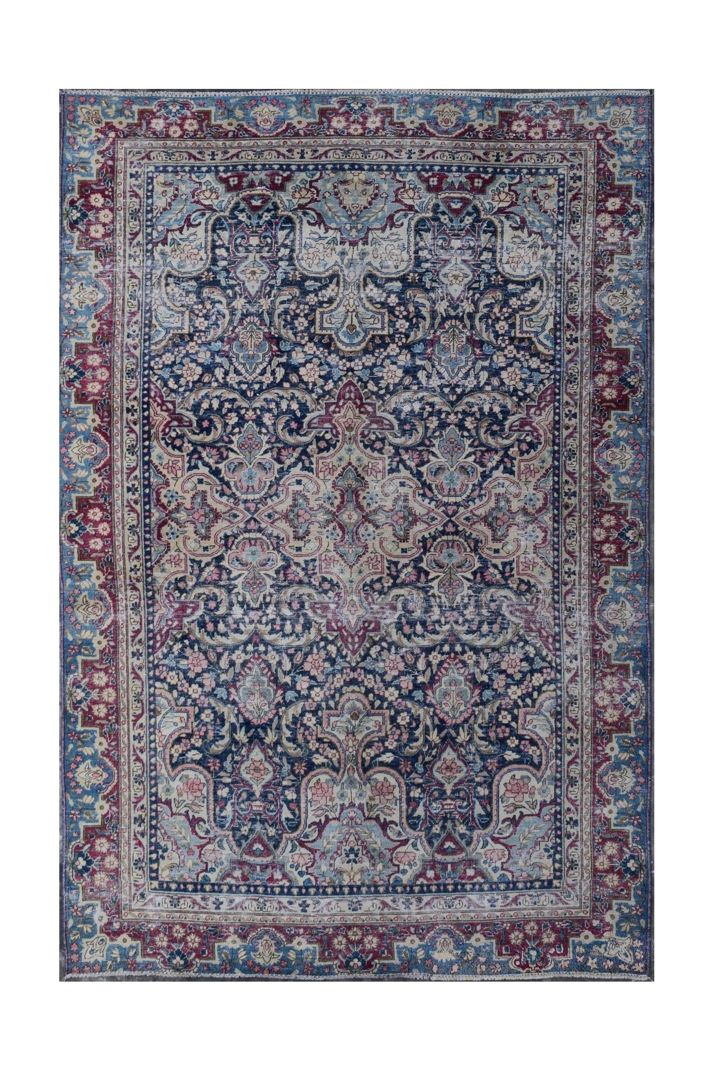 A vintage Persian Kerman rug featuring an intricate floral medallion design in blue and red tones.