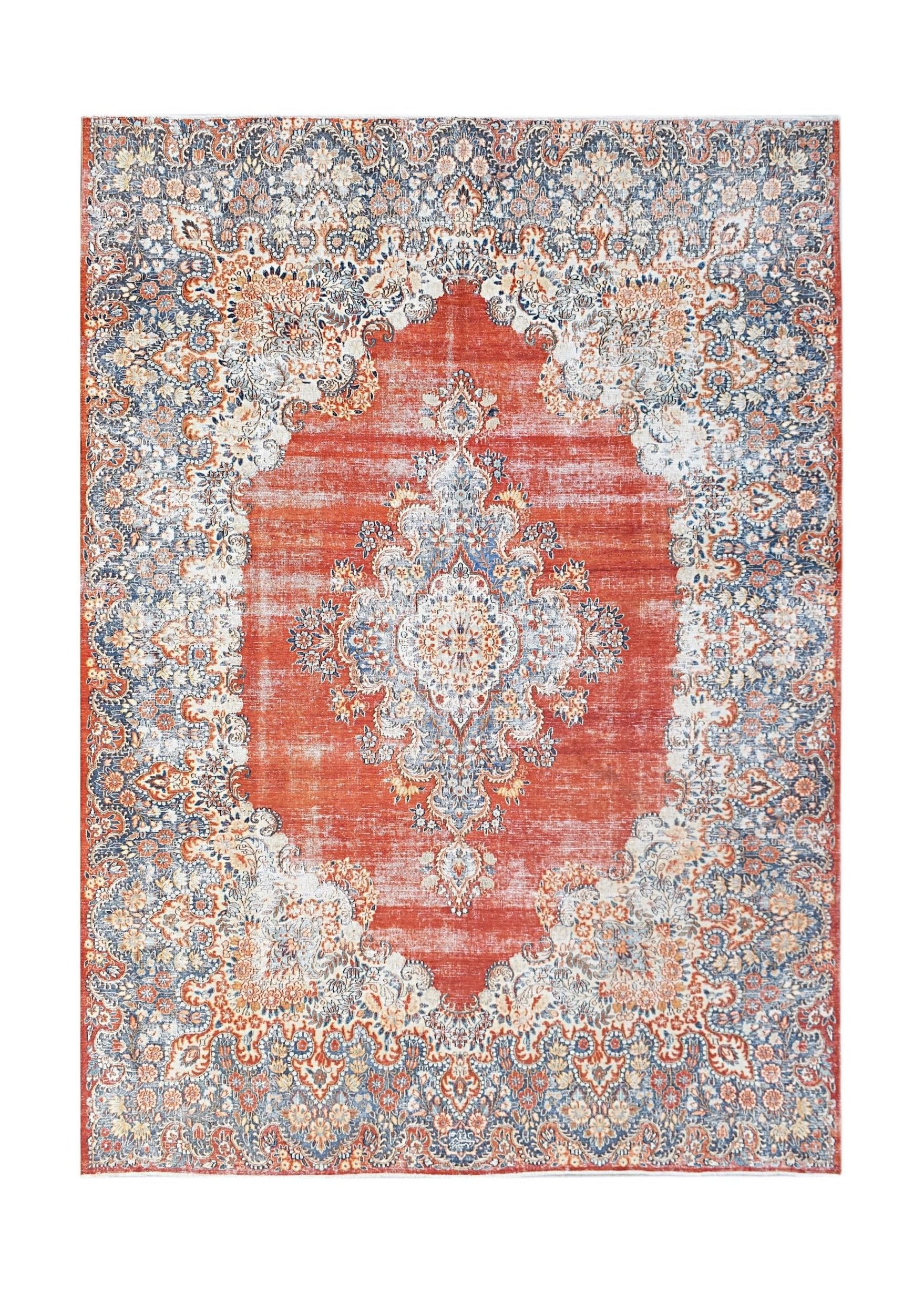A vintage Persian Kerman rug featuring a central medallion and intricate floral patterns in red.