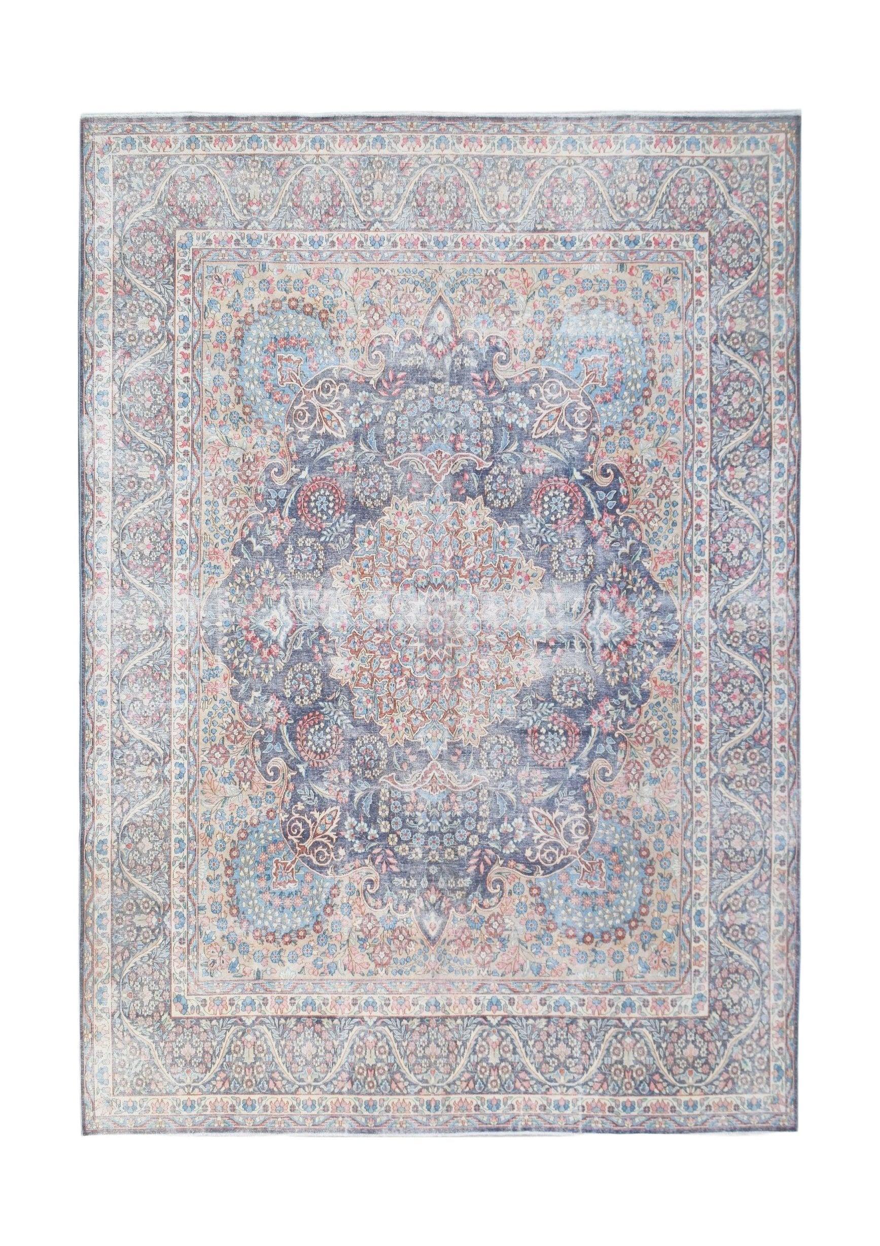 A vintage Persian Kerman rug featuring a central medallion and intricate floral patterns in blue.