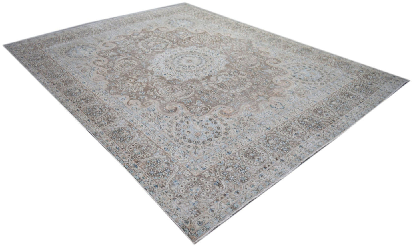 A vintage Persian Kerman rug featuring an intricate floral medallion design in soft neutral tones.