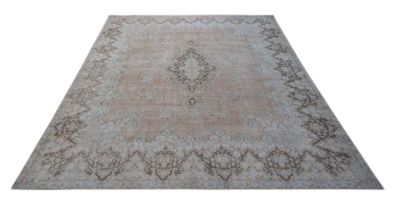 A vintage Persian Kerman rug featuring a central medallion and intricate floral patterns in beige.