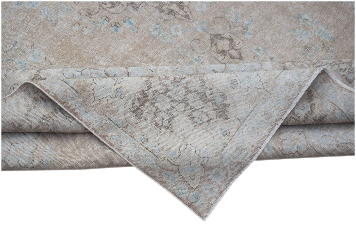 A vintage Persian Kerman rug featuring a beige field with intricate blue and brown floral patterns.