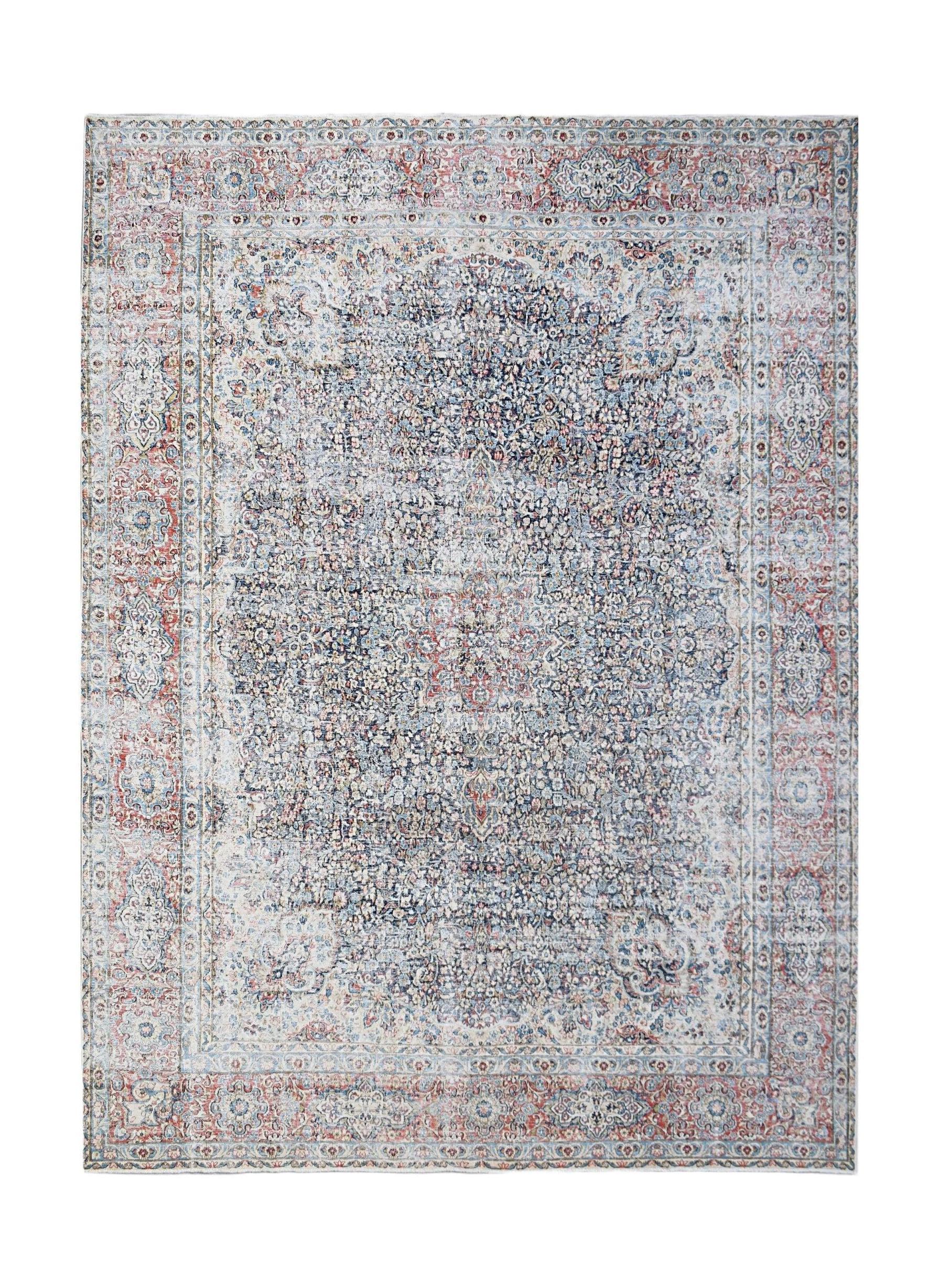A vintage Persian Kerman rug featuring a central medallion and intricate floral patterns in blue.