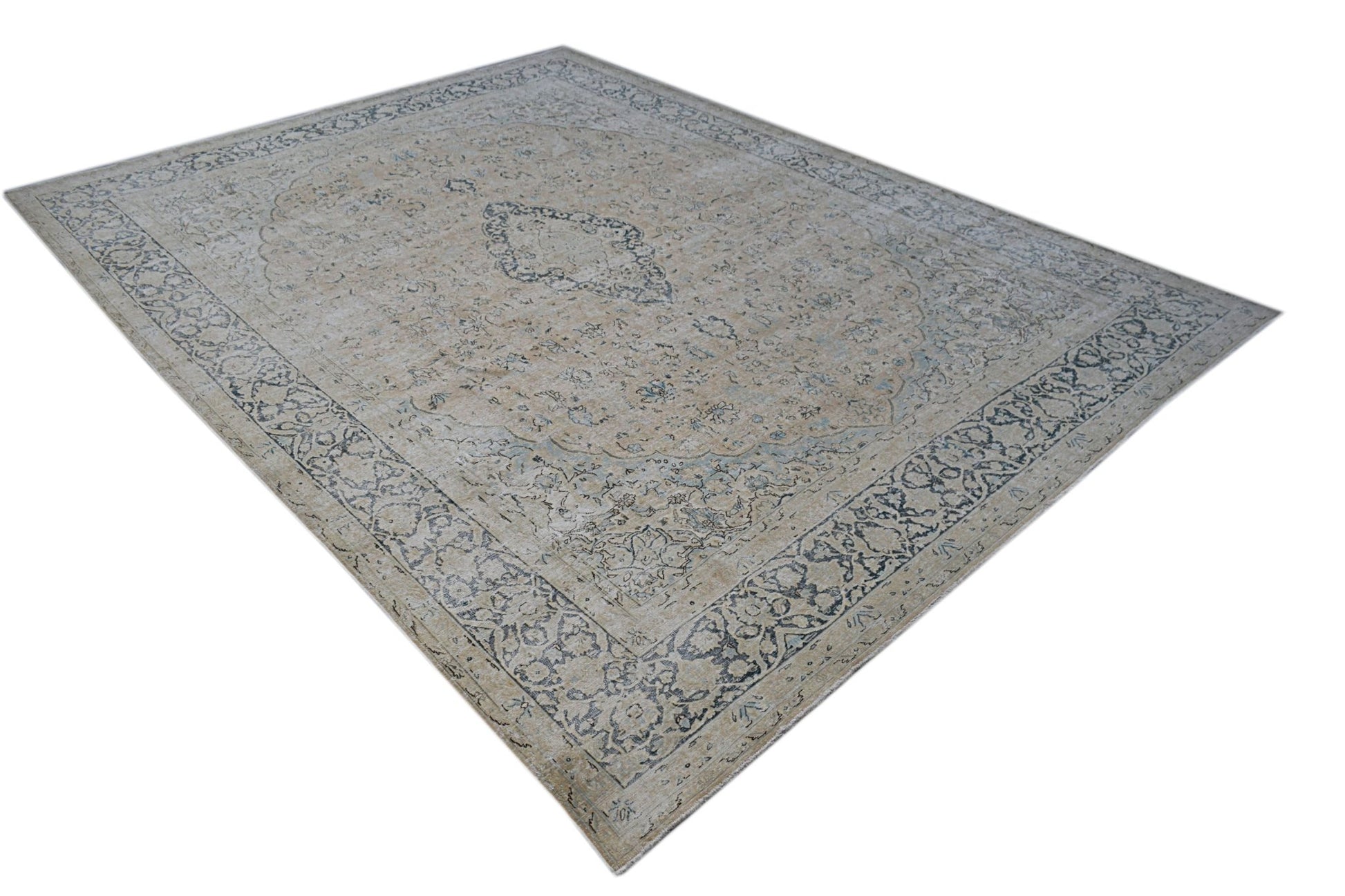 A vintage Persian Kerman rug featuring a central medallion and intricate floral border patterns.
